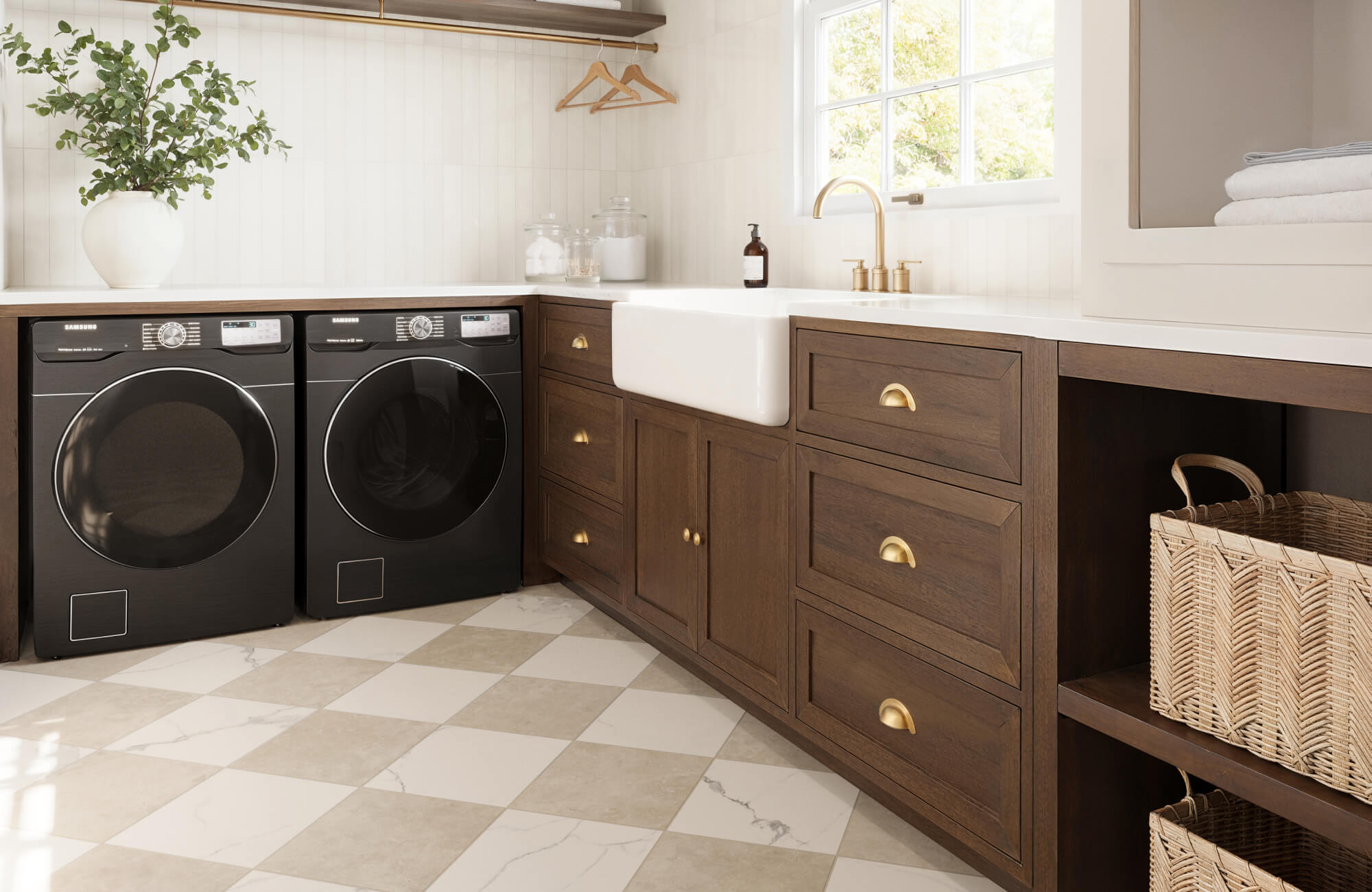 Chic laundry room with cream and beige marble-look checkerboard tiles, dark wood cabinetry, and modern black appliances