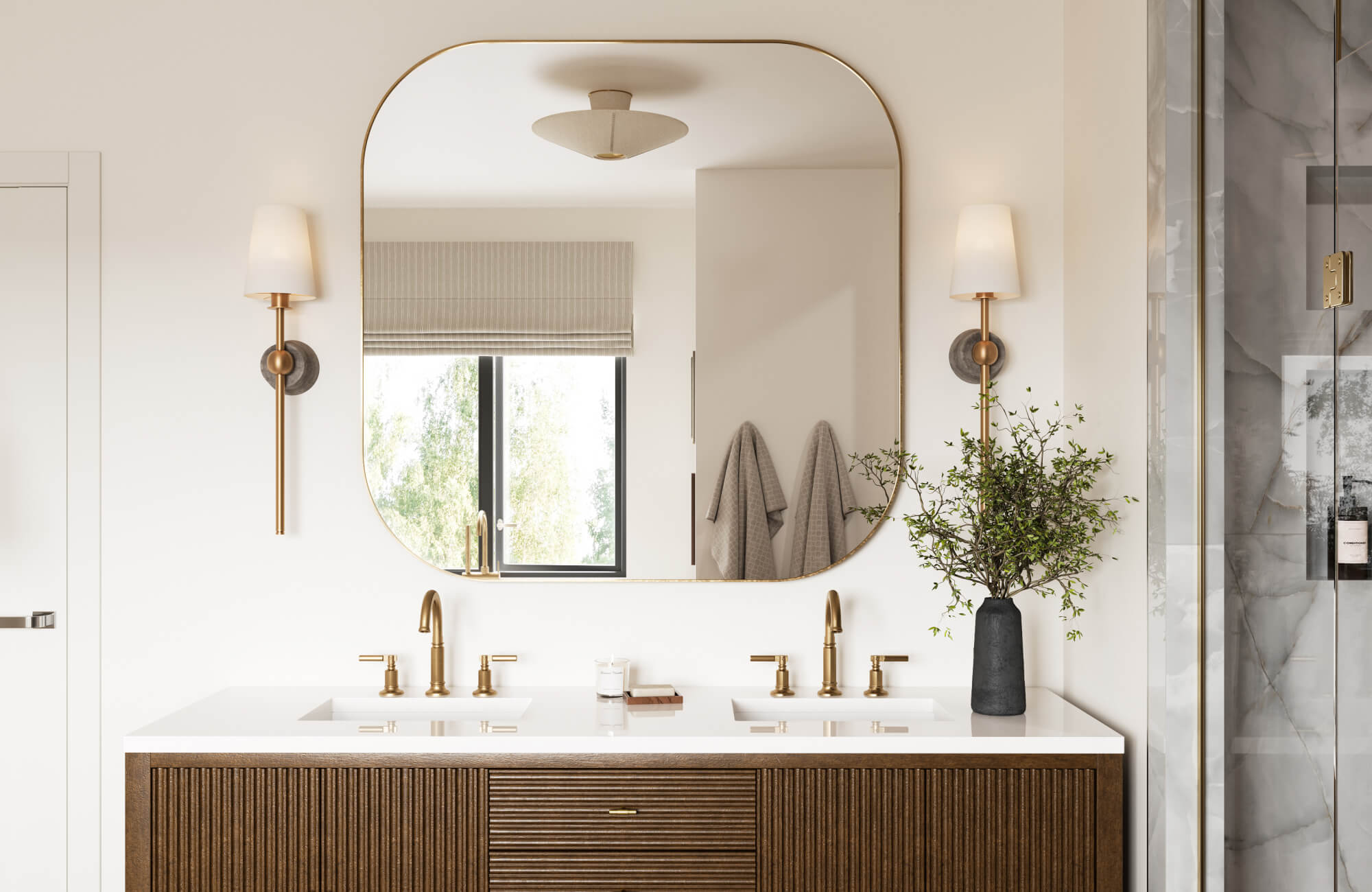 Refined bathroom with a fluted wood vanity, brushed brass fixtures, and wall sconces flanking a large square mirror.