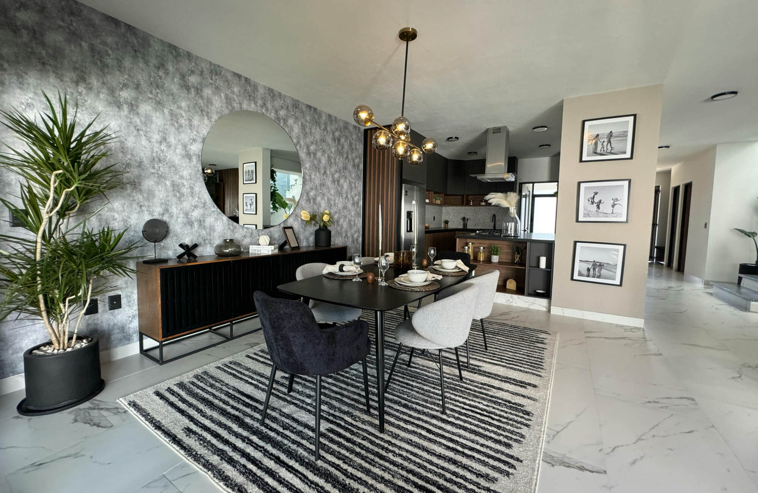 Large round mirror reflecting a modern dining room with a dark table and a patterned rug