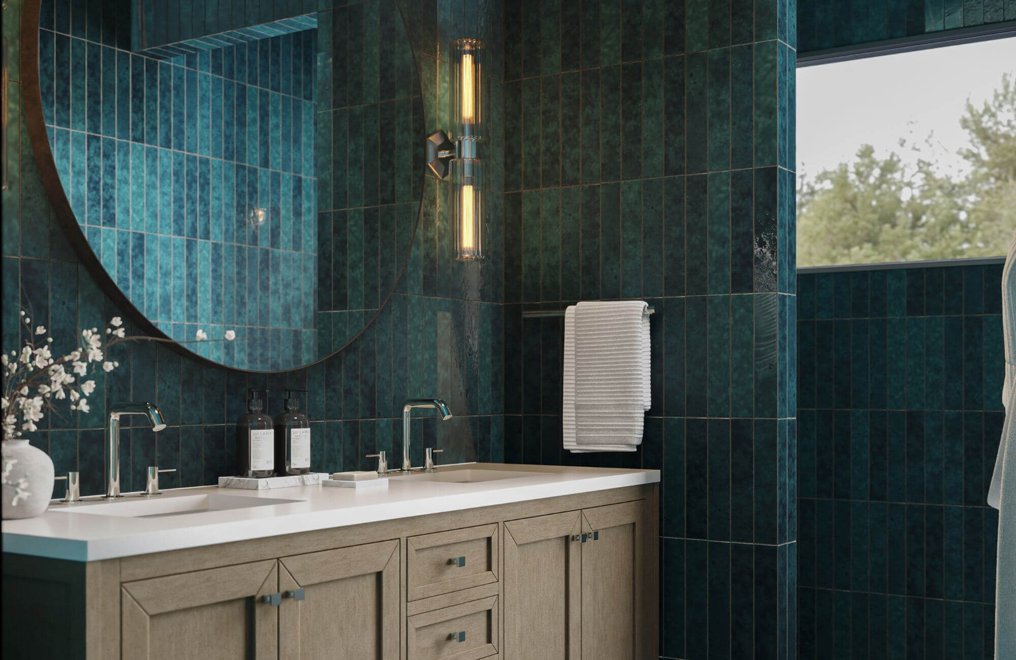 Modern bathroom with deep green vertical subway tiles, wood vanity, round mirror, and warm wall lighting creating a rich, spa-like feel.