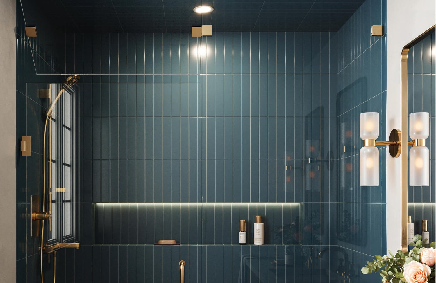 Glossy dark blue vertical subway tile shower with brass fixtures, glass enclosure, recessed shelf, wall sconces, and a matching tiled ceiling.
