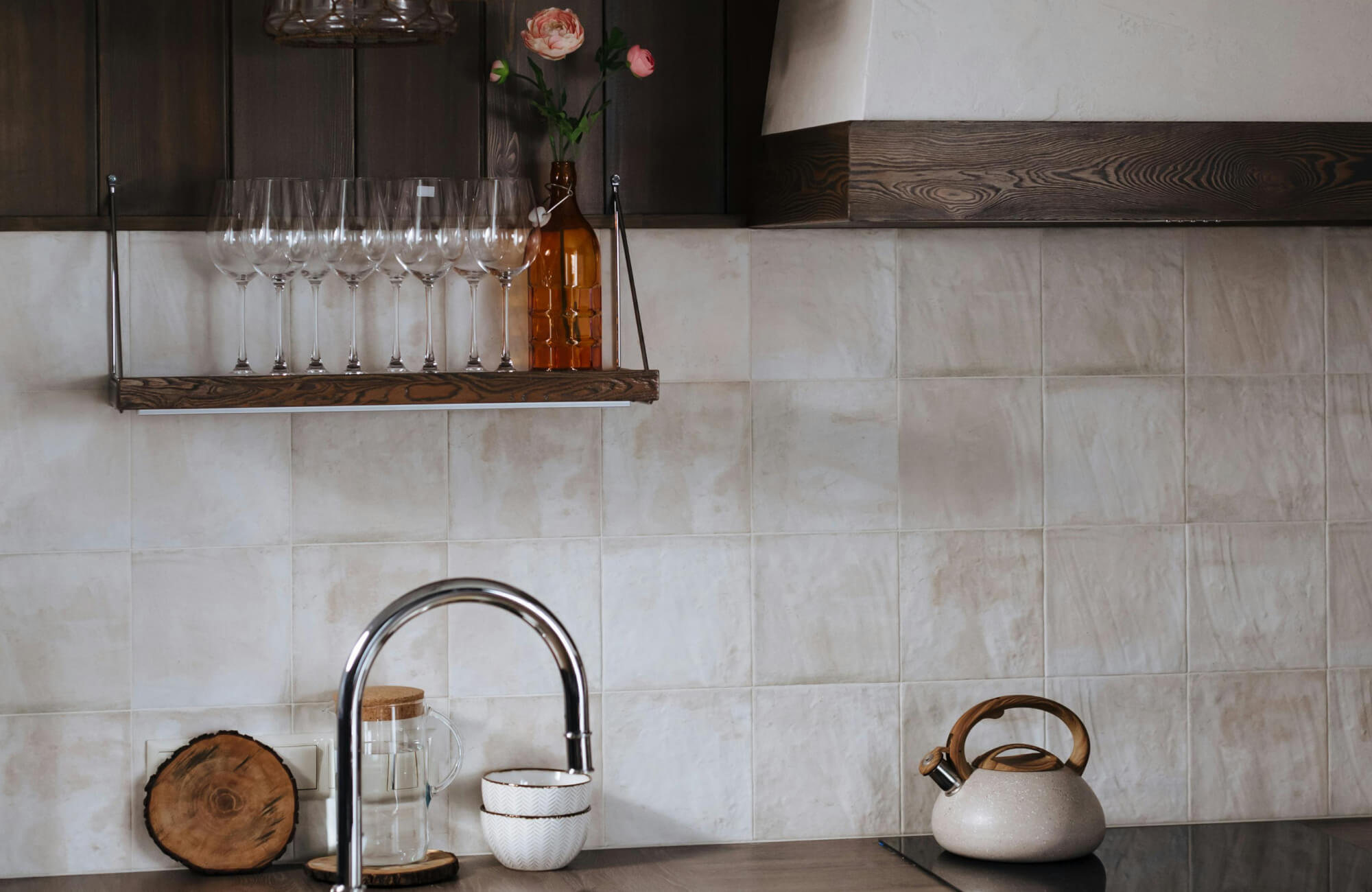 Warm-toned Zellige backsplash tiles with subtle color variations, adding texture and depth to a rustic kitchen space.
