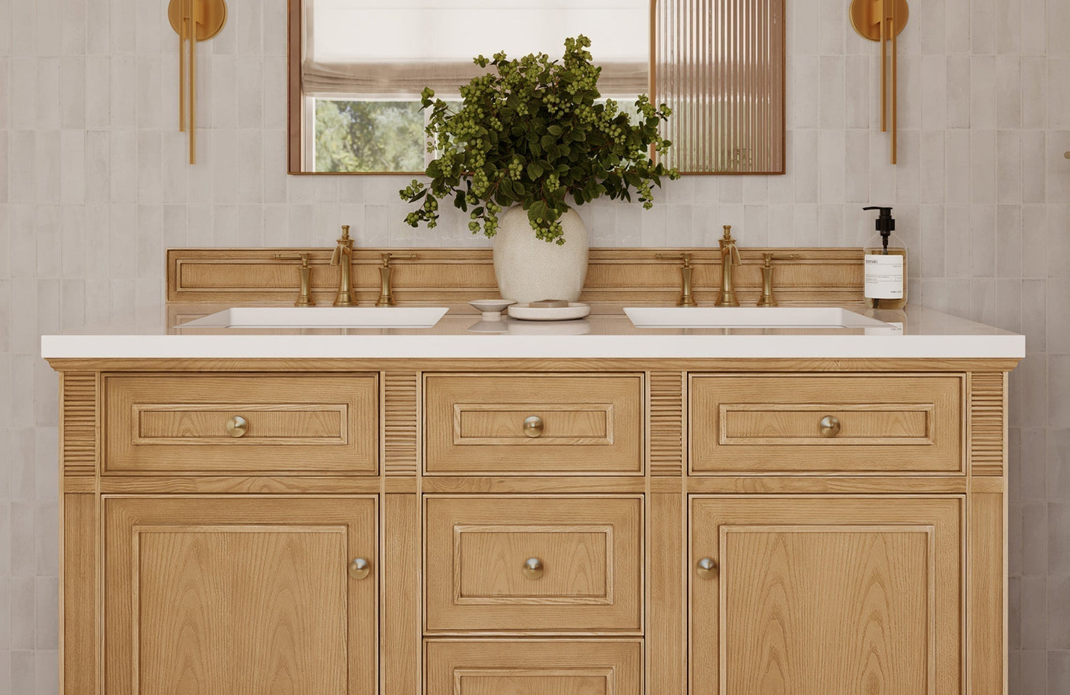 Light wood double vanity with brass hardware and quartz top, styled with greenery for a rustic yet refined bathroom look.