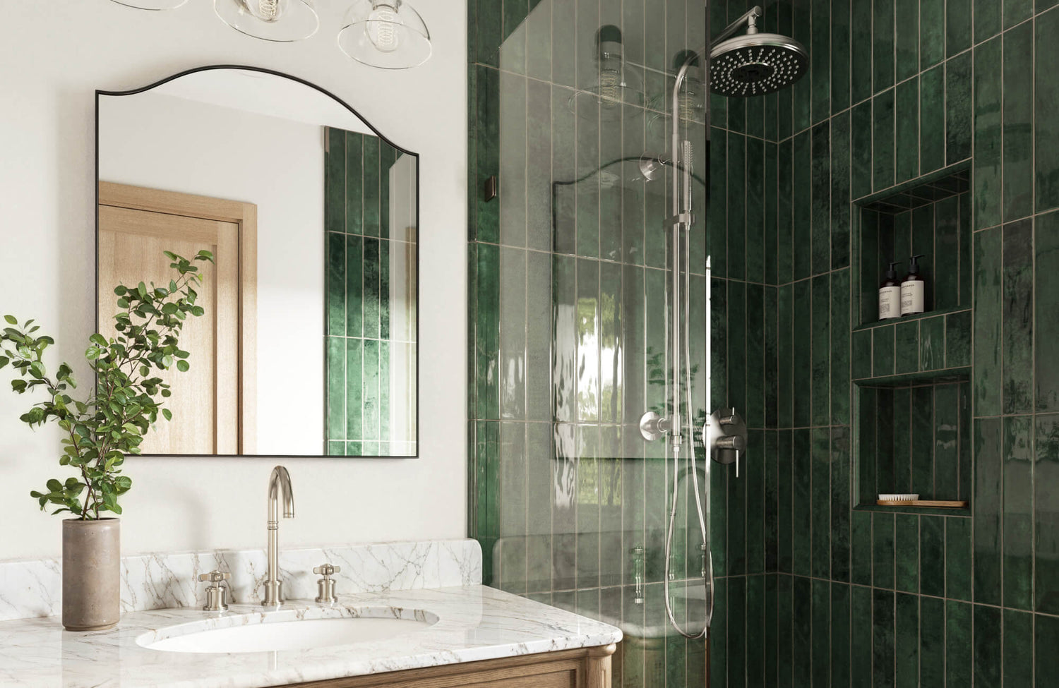 Modern bathroom with deep green vertical subway tiles, a glass shower, marble vanity, and a built-in niche for storage.