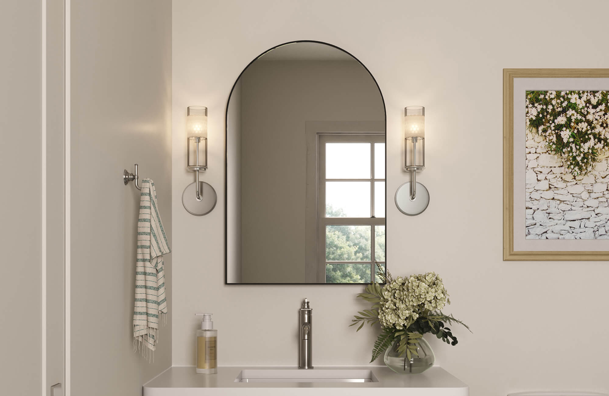 Arched mirror paired with vertical wall sconces, creating balanced vanity lighting that frames the reflection with soft, even illumination.