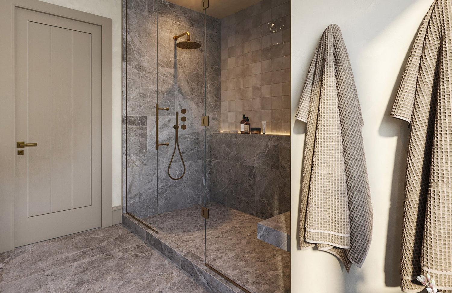 Walk-in shower with gray stone-look tiles on walls and floors, paired with a rainfall showerhead and glass enclosure.