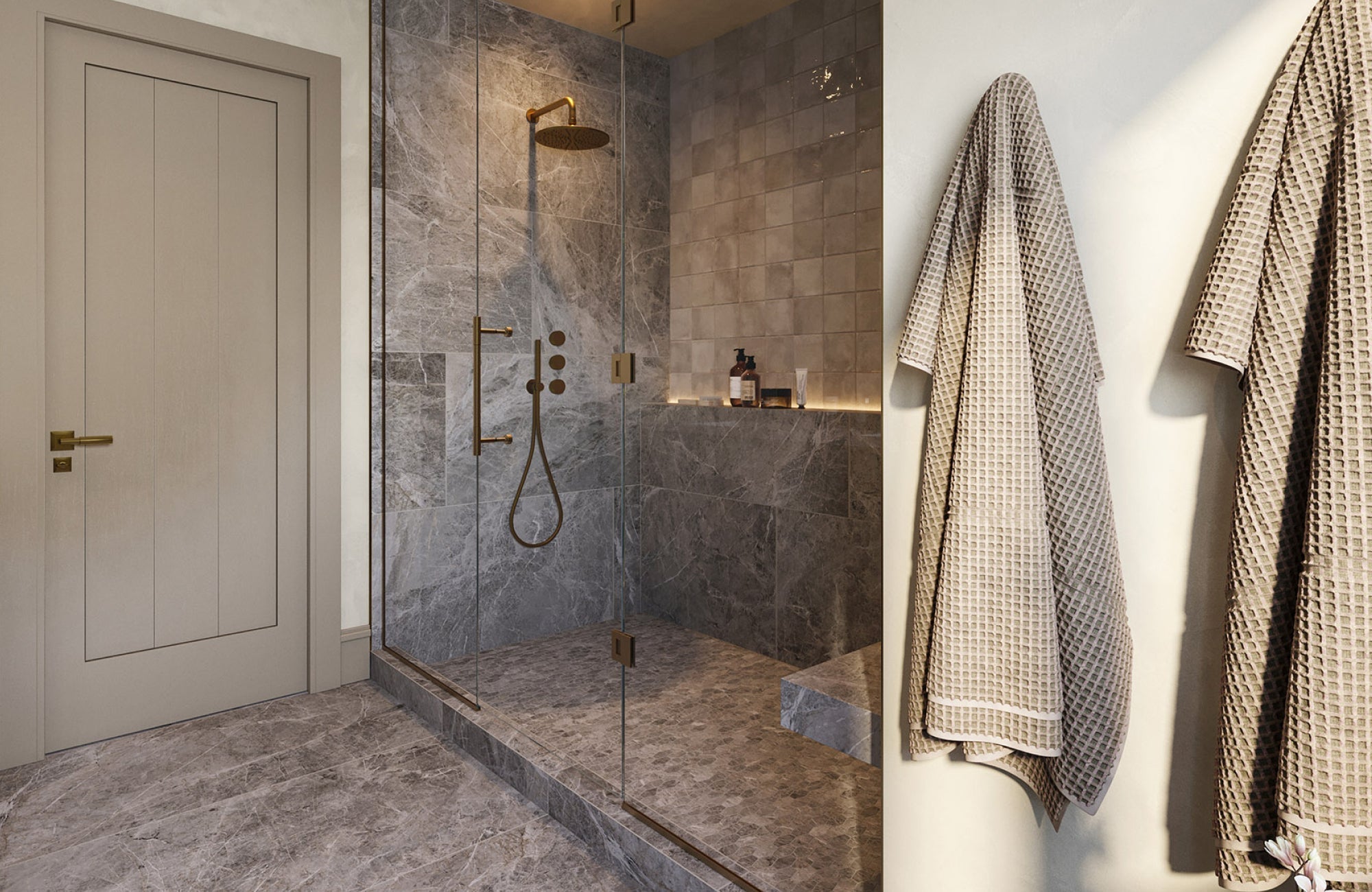 Walk-in shower with gray stone-look tiles on walls and floors, paired with a rainfall showerhead and glass enclosure.