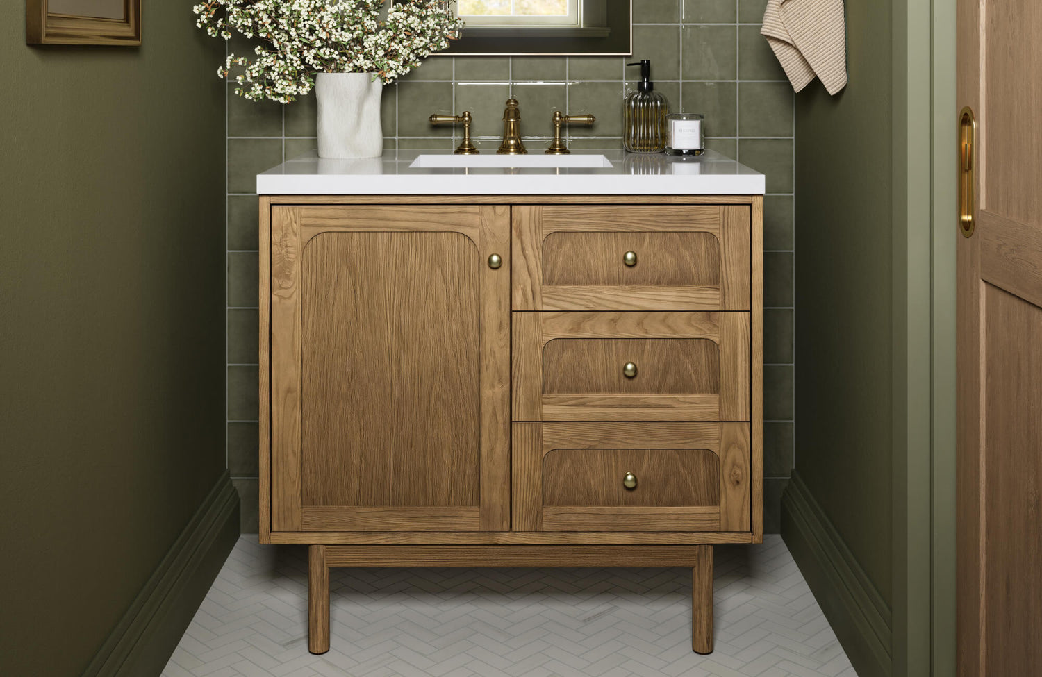 Modern bathroom vanity in natural wood with brass hardware, crisp white countertop, and a green tile backsplash for a warm yet contemporary look.