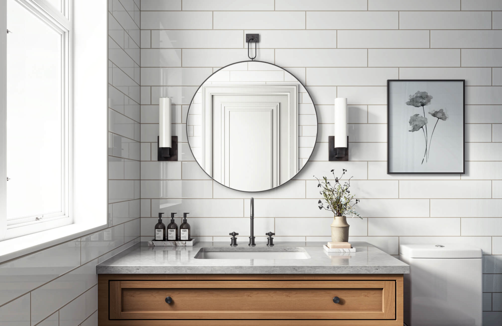 Crisp bathroom with glossy white subway tiles, a round mirror, a wood vanity, and matte black fixtures