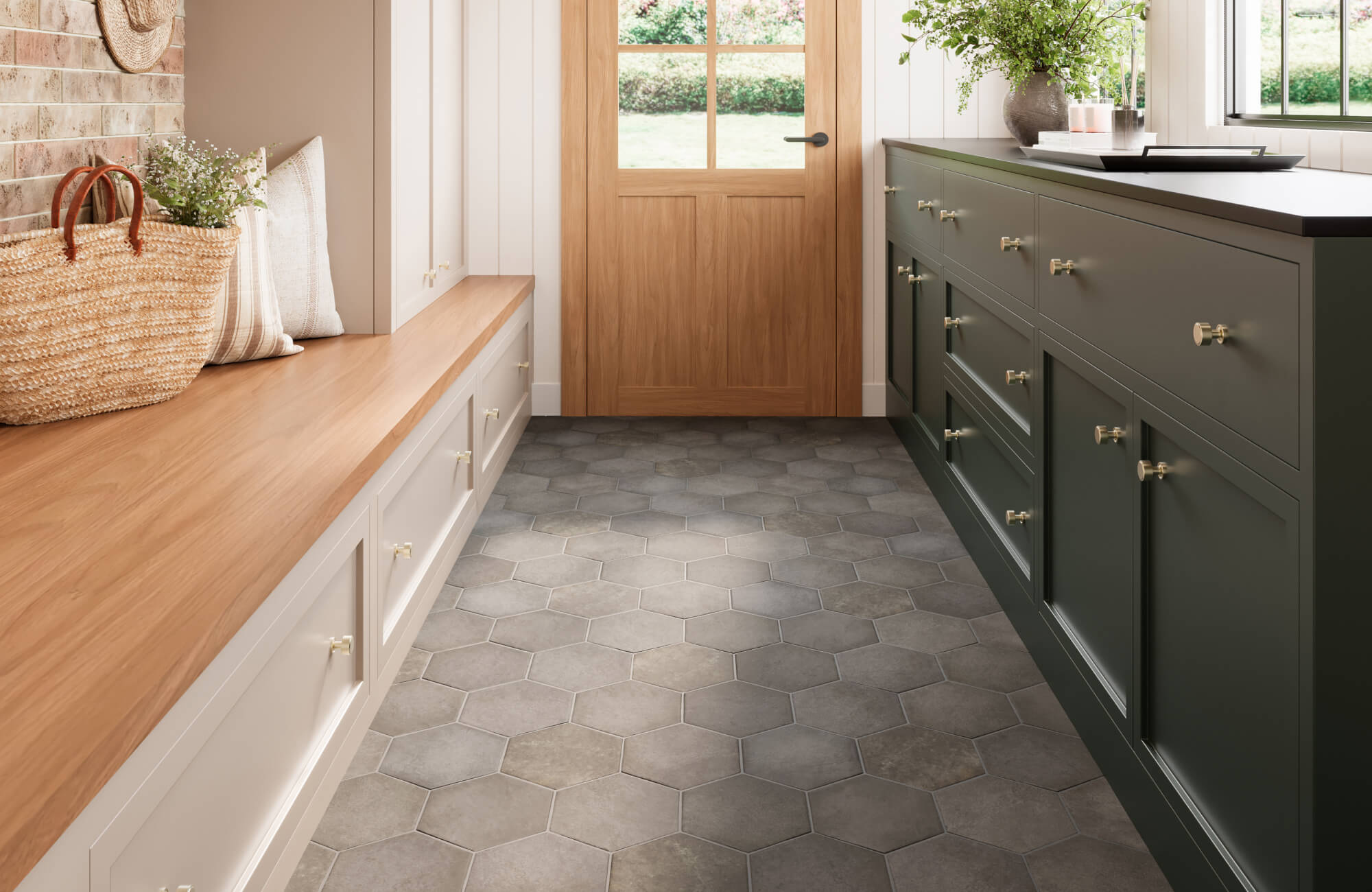 Inviting mudroom with hexagonal cement look floor tiles in warm grey, paired with green cabinetry and natural wood accents.