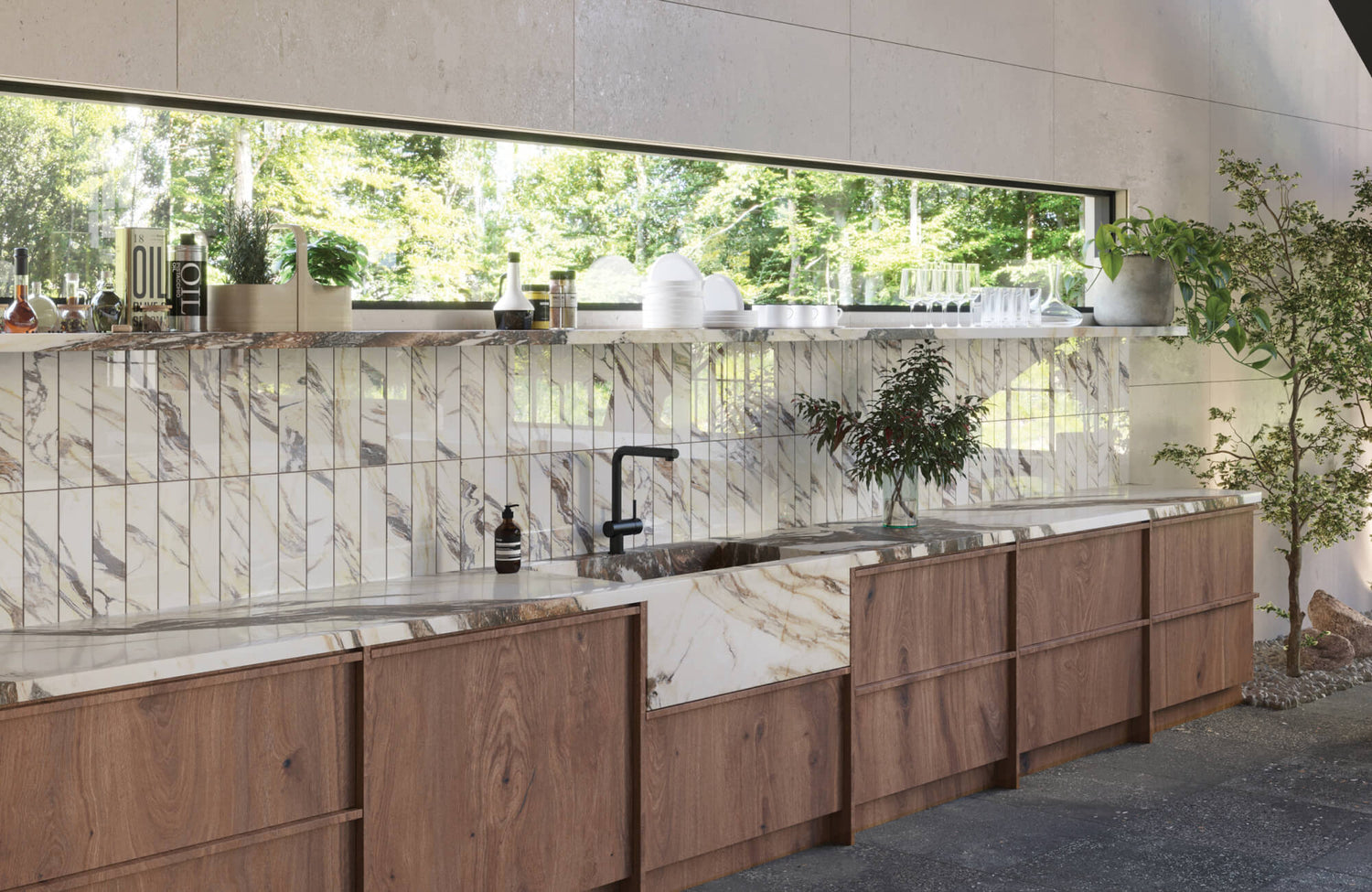 Contemporary kitchen featuring elegant marble look tile backsplash with vertical lines, paired with warm wood cabinetry and natural light from a large window.