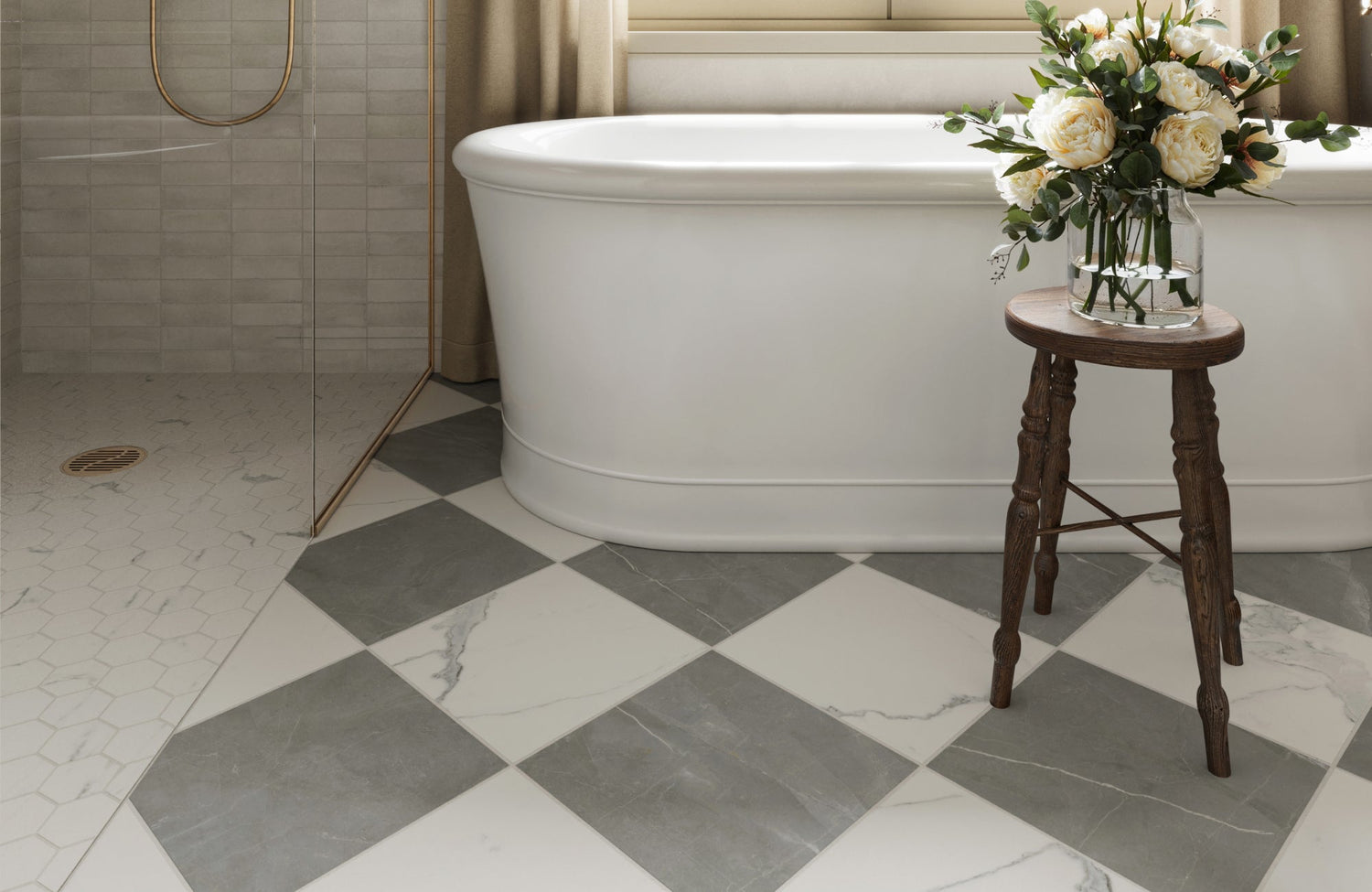 Serene bathroom with gray and white checkered tiles, a freestanding tub, and a hexagonal tiled shower accented by brass trim for timeless elegance.