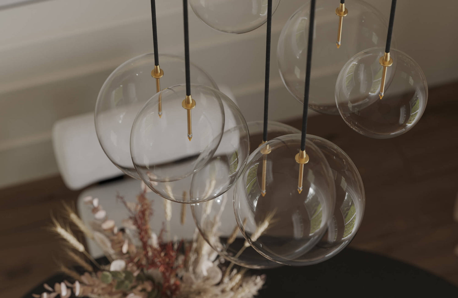 Decorative lighting with modern glass globe pendant fixtures suspended by black cords and accented with gold details creates a sophisticated and airy ambiance.