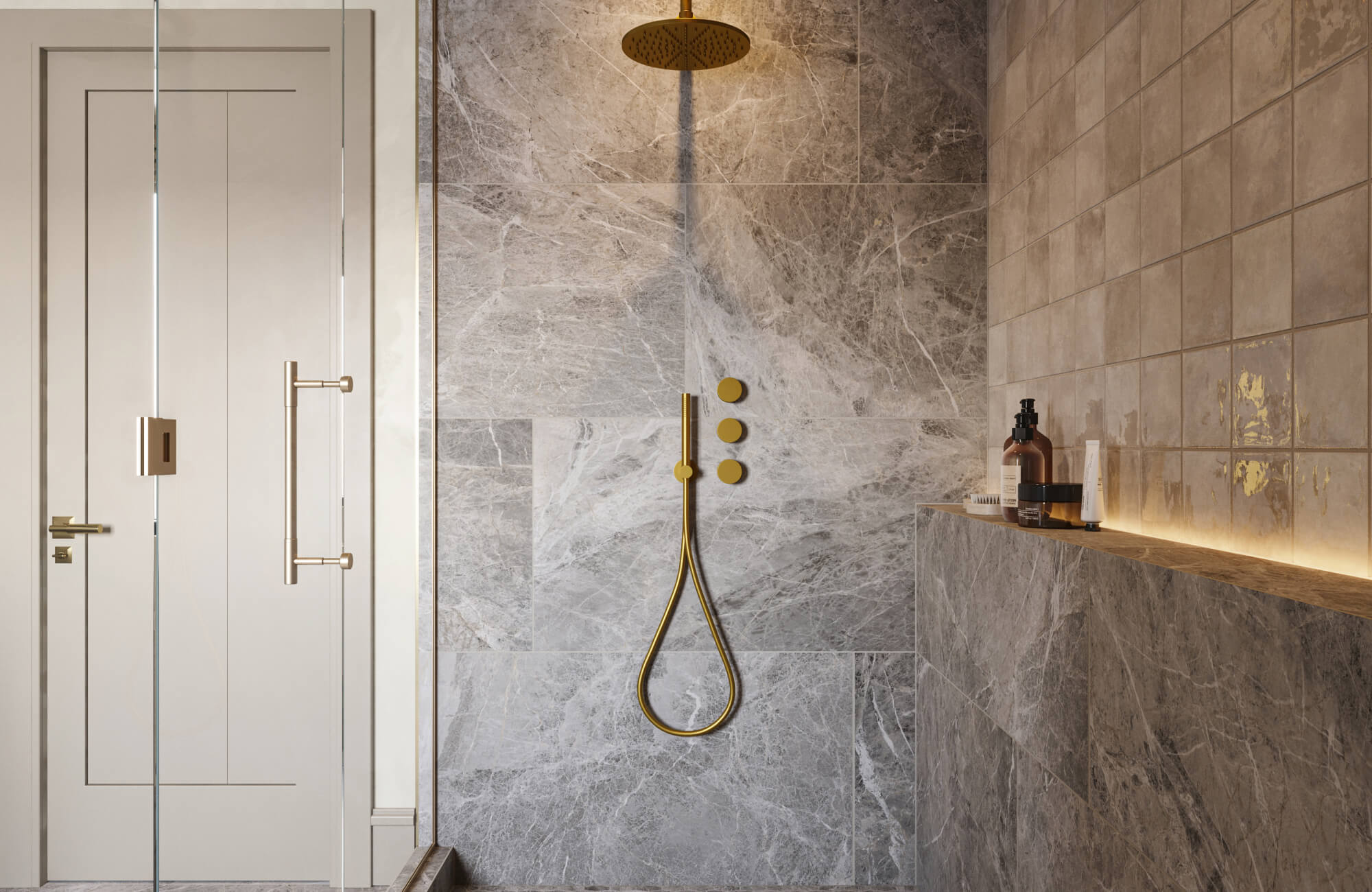 Walk-in shower with gray marble tile walls, gold rainfall showerhead, and built-in ledge with toiletries.