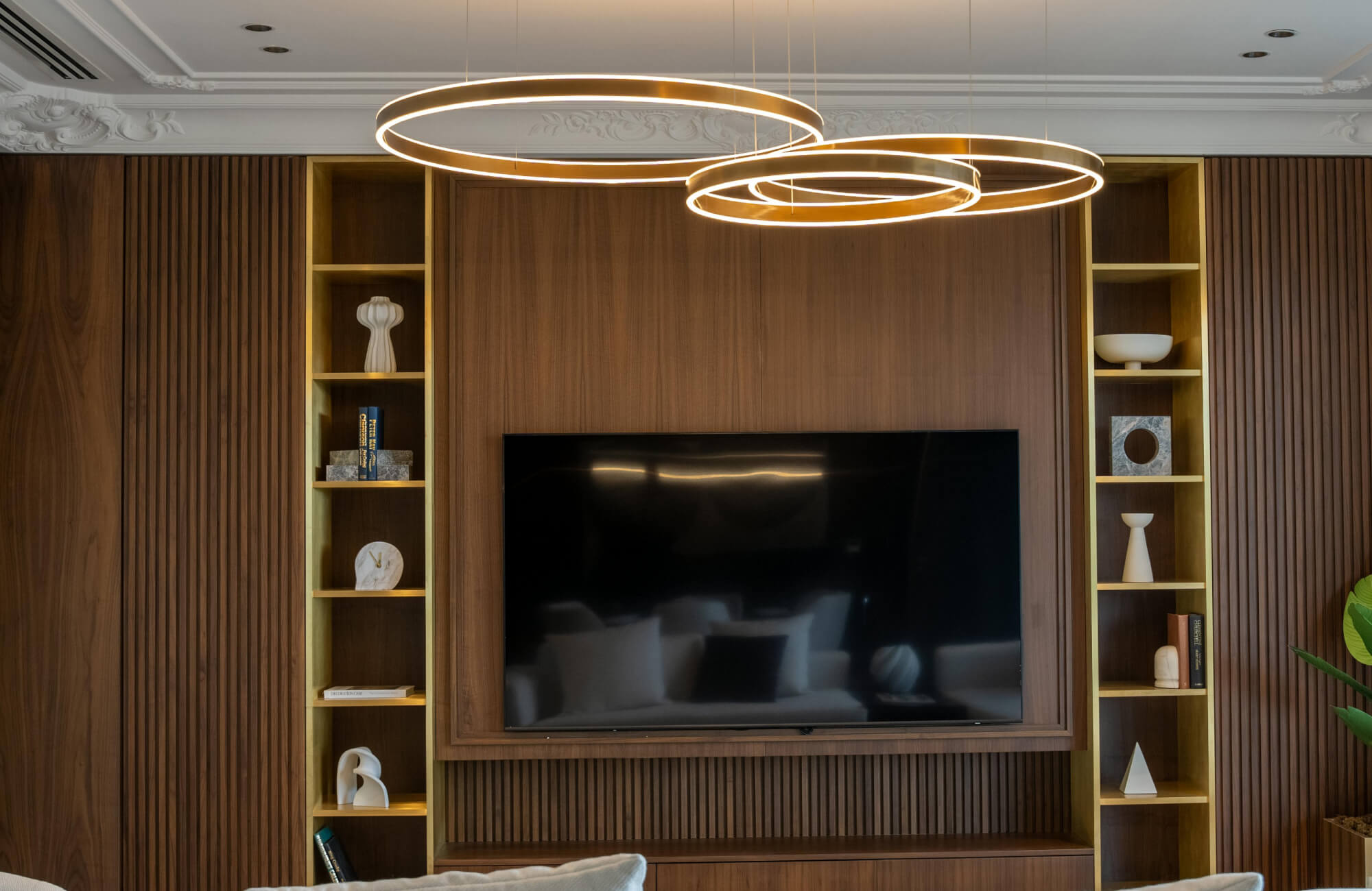 Geometric chandelier with interlocking black metal frames and exposed bulbs in a polished chrome core.