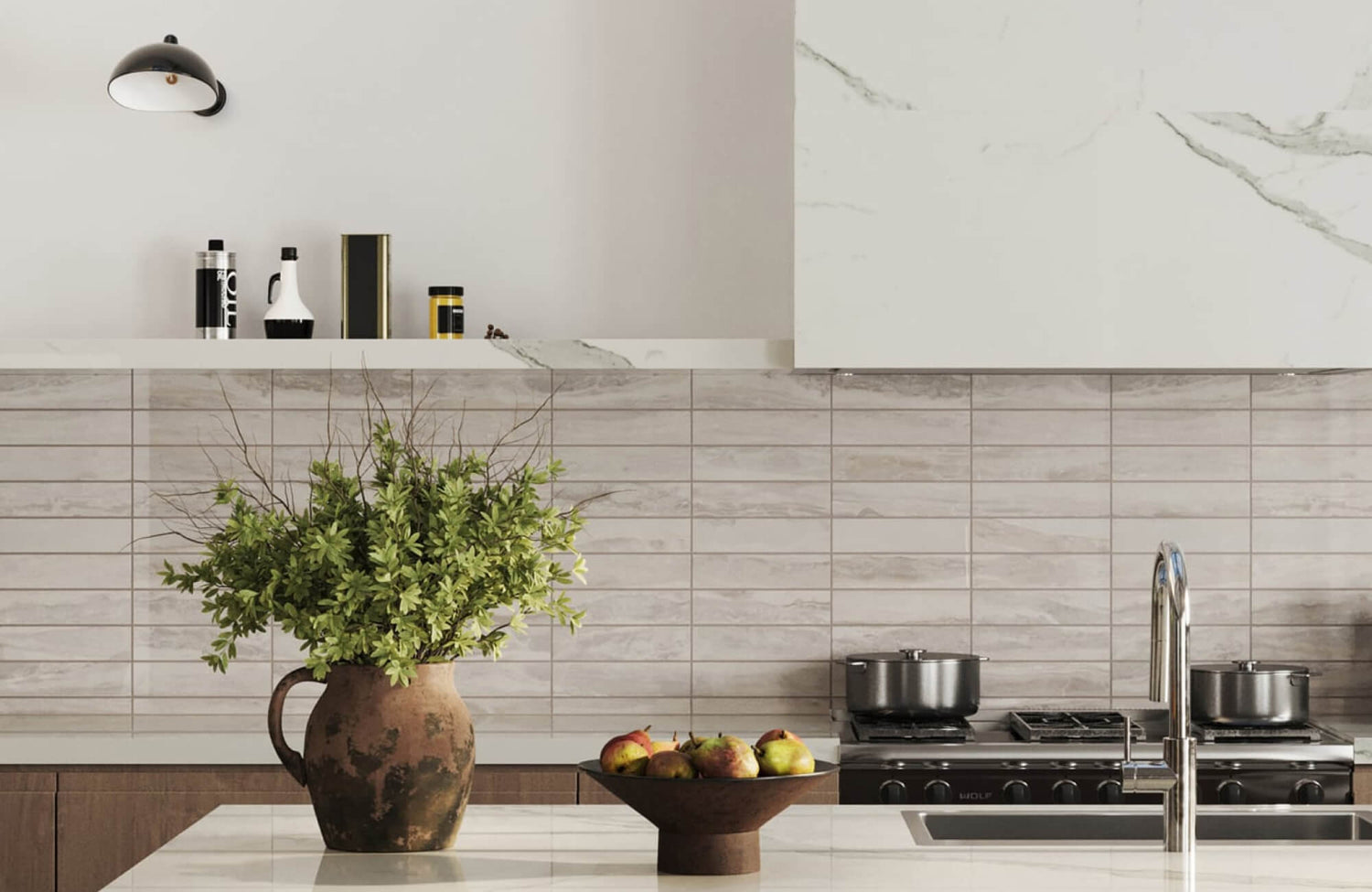 Kitchen with beige variegated subway tile backsplash, white marble-look range hood, open shelf, wood cabinetry, and a white island countertop