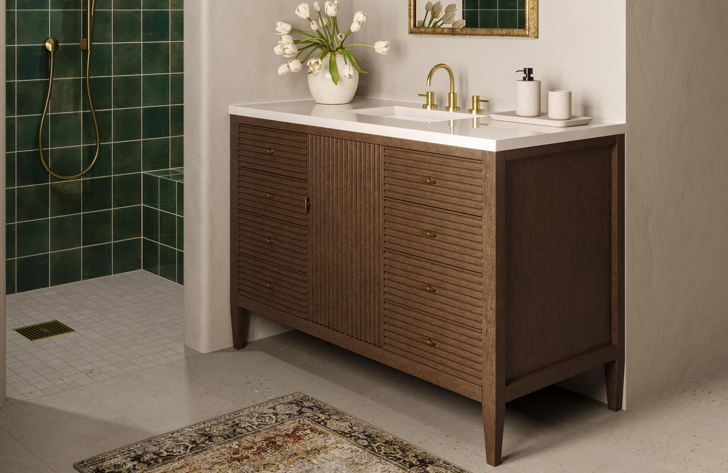 Glossy emerald green shower tiles add a bold contrast to the neutral stone floor and warm, mid-century-inspired vanity.