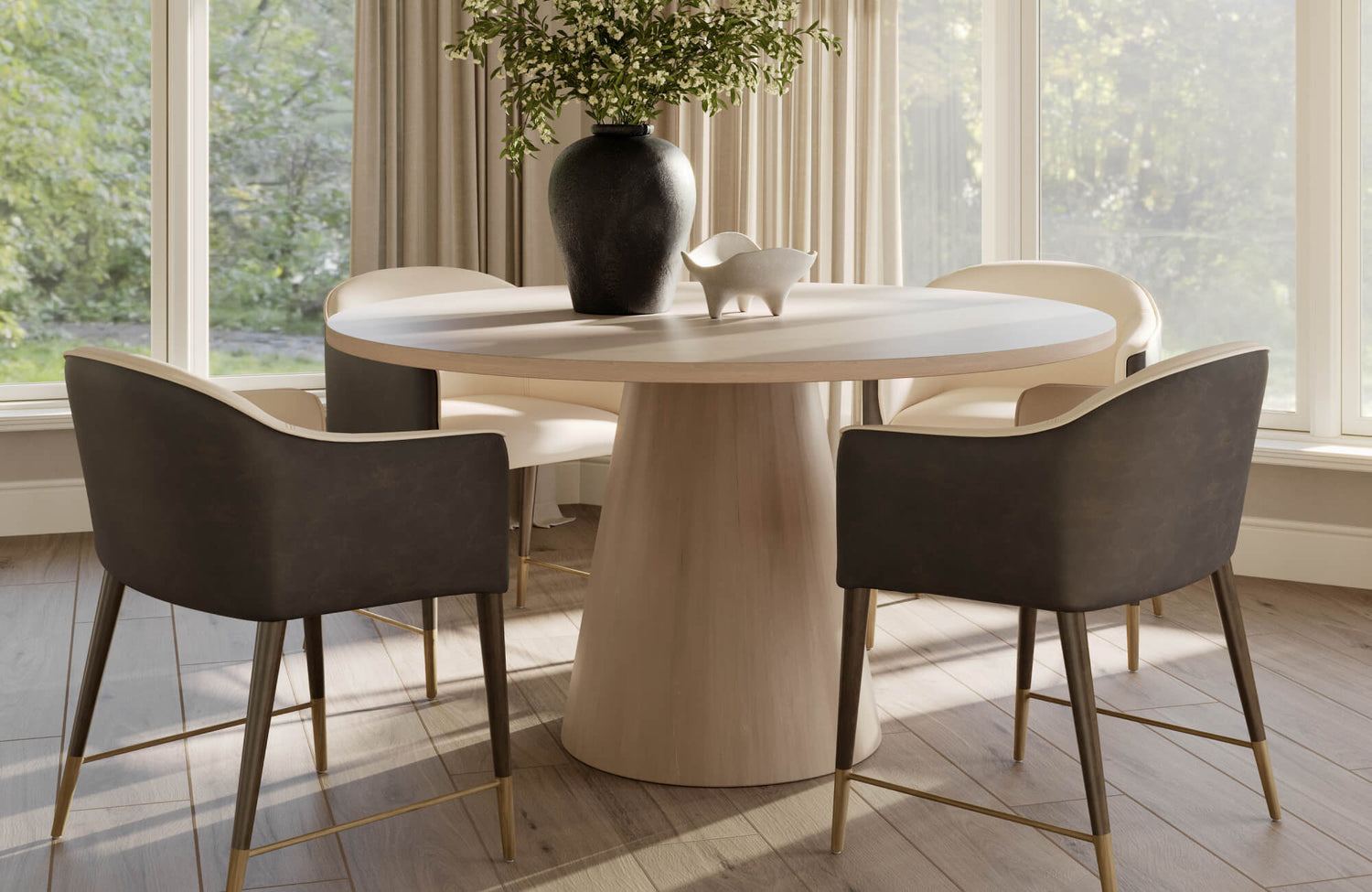 Sculpted round wood table with modern black vase and cream-accent chairs on warm-toned wood look tile flooring.