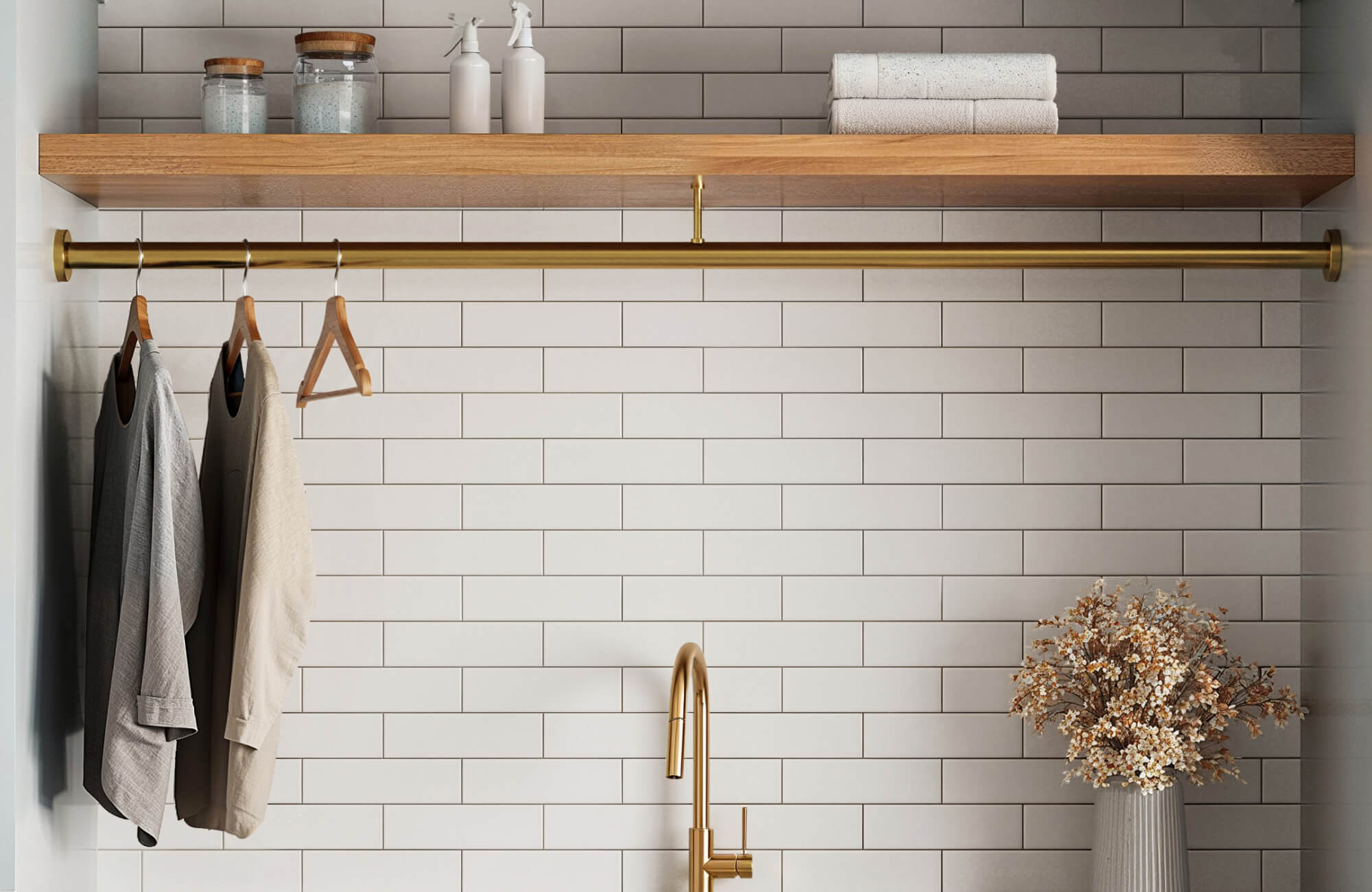 White subway tiles with light grey grout create a soft grid in this laundry room, paired with wood and brass accents.