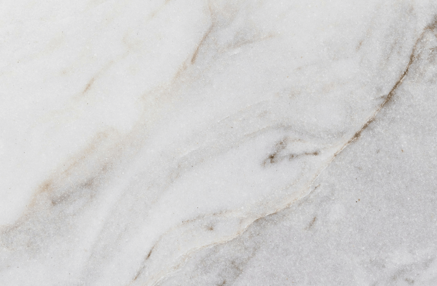 Luxurious marble surface featuring soft gray and white swirls with delicate veining, exuding timeless elegance and natural charm.