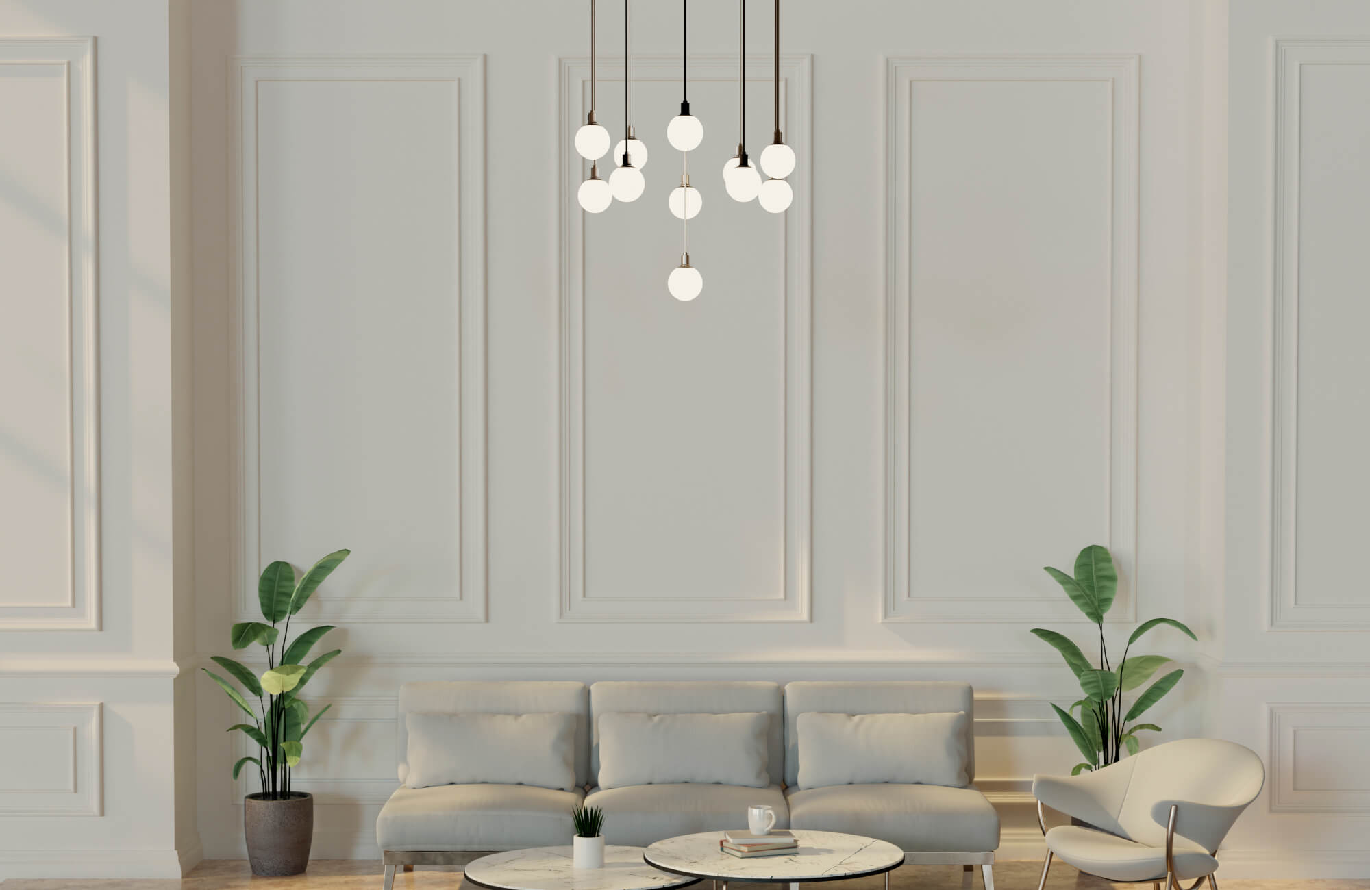 Elegant minimalist living room with soft globe pendant lighting, a neutral sofa, marble coffee tables, and lush potted plants adding natural balance.