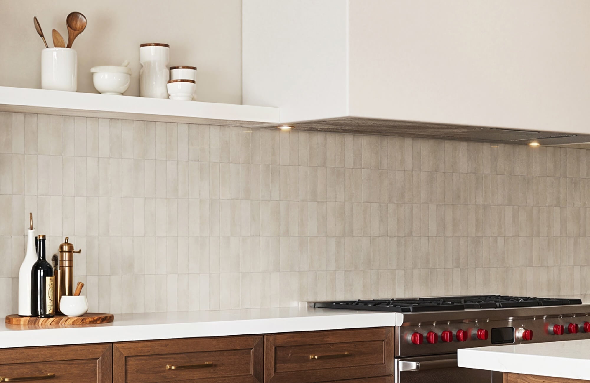 Soft beige vertical subway tiles add subtle texture and warmth to a modern kitchen backsplash.