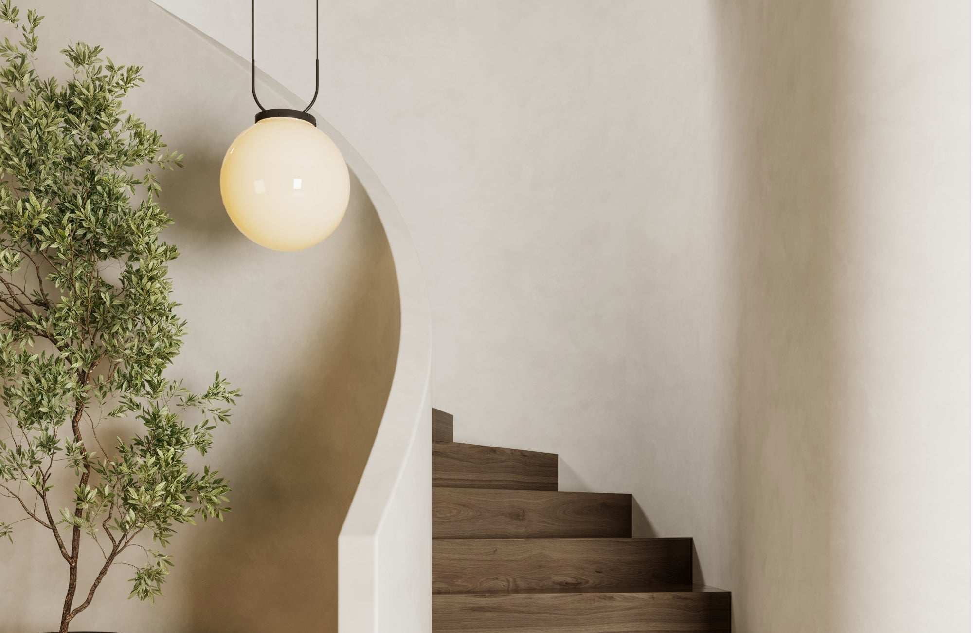 Pendant light with a soft globe shade hanging near a staircase, adding warmth and contrast to the neutral space.