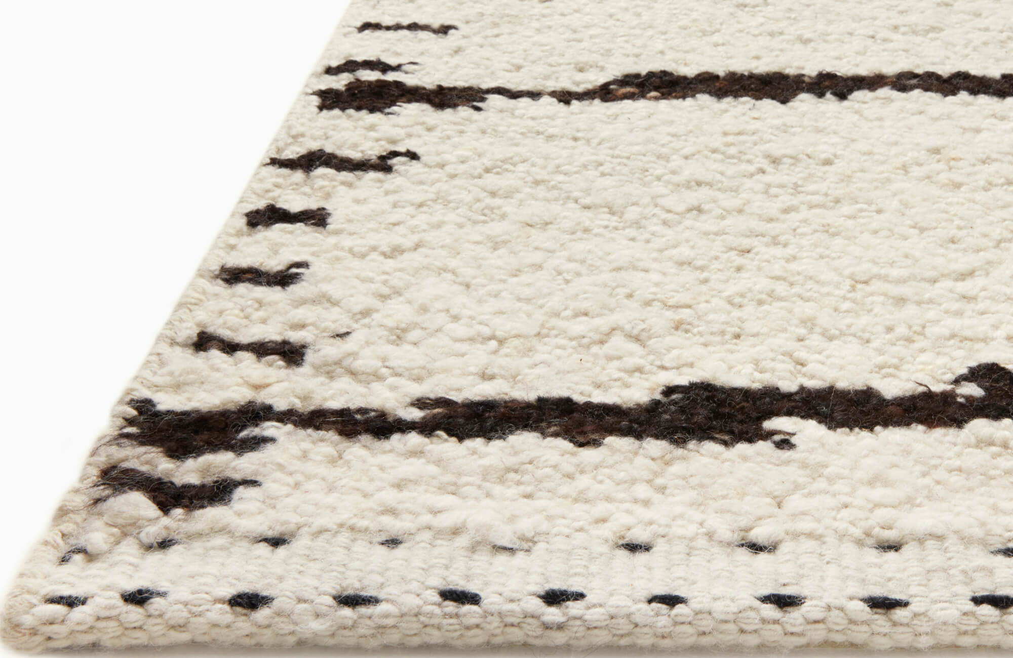 Plush, handwoven wool rug with a cream base and abstract black linear patterns, offering a modern yet organic aesthetic.
