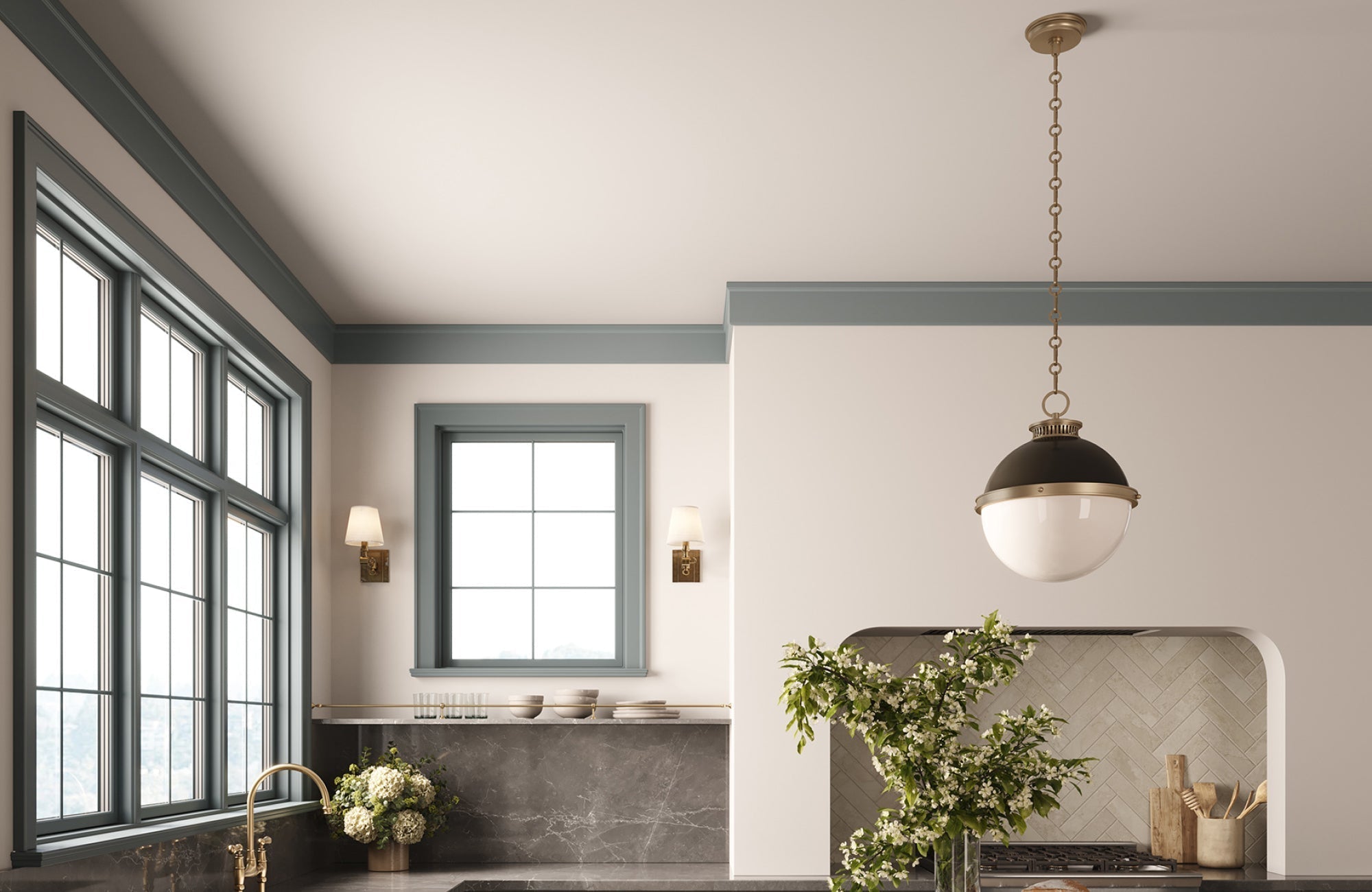 Pendant light suspended at balanced height above kitchen counter, showing proper drop for visual symmetry and task lighting.