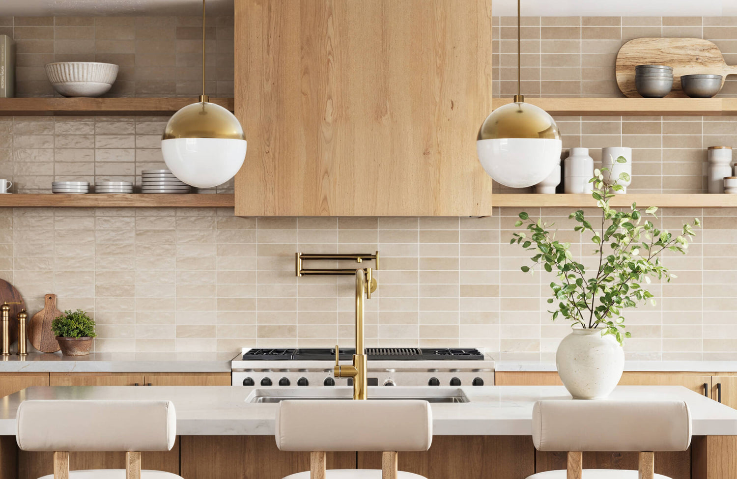 Modern kitchen with globe pendants, gold accents, light wood cabinets, open shelves, and a central island with a brass faucet