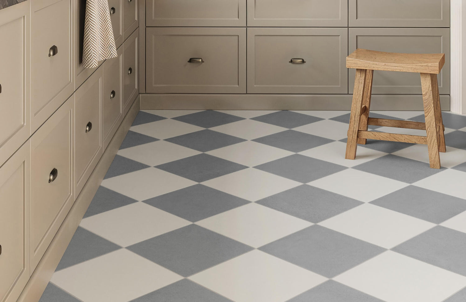 A checkered floor with soft gray and white tiles adds timeless charm, creating a spacious and visually dynamic effect in this cozy space.