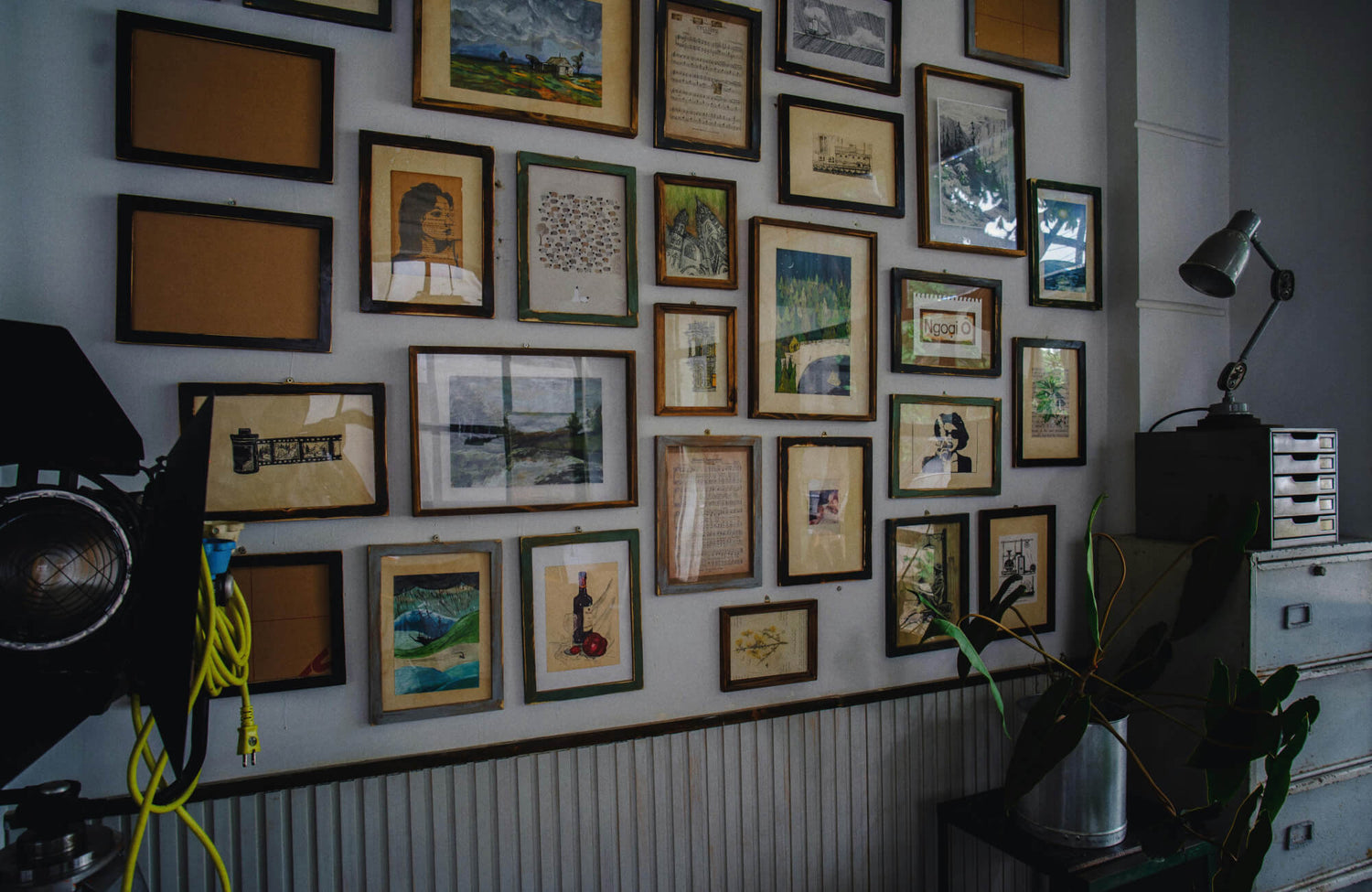 A dense gallery wall arrangement featuring mixed frame sizes and styles, demonstrating how varied artwork can be grouped cohesively with balanced spacing and visual flow.