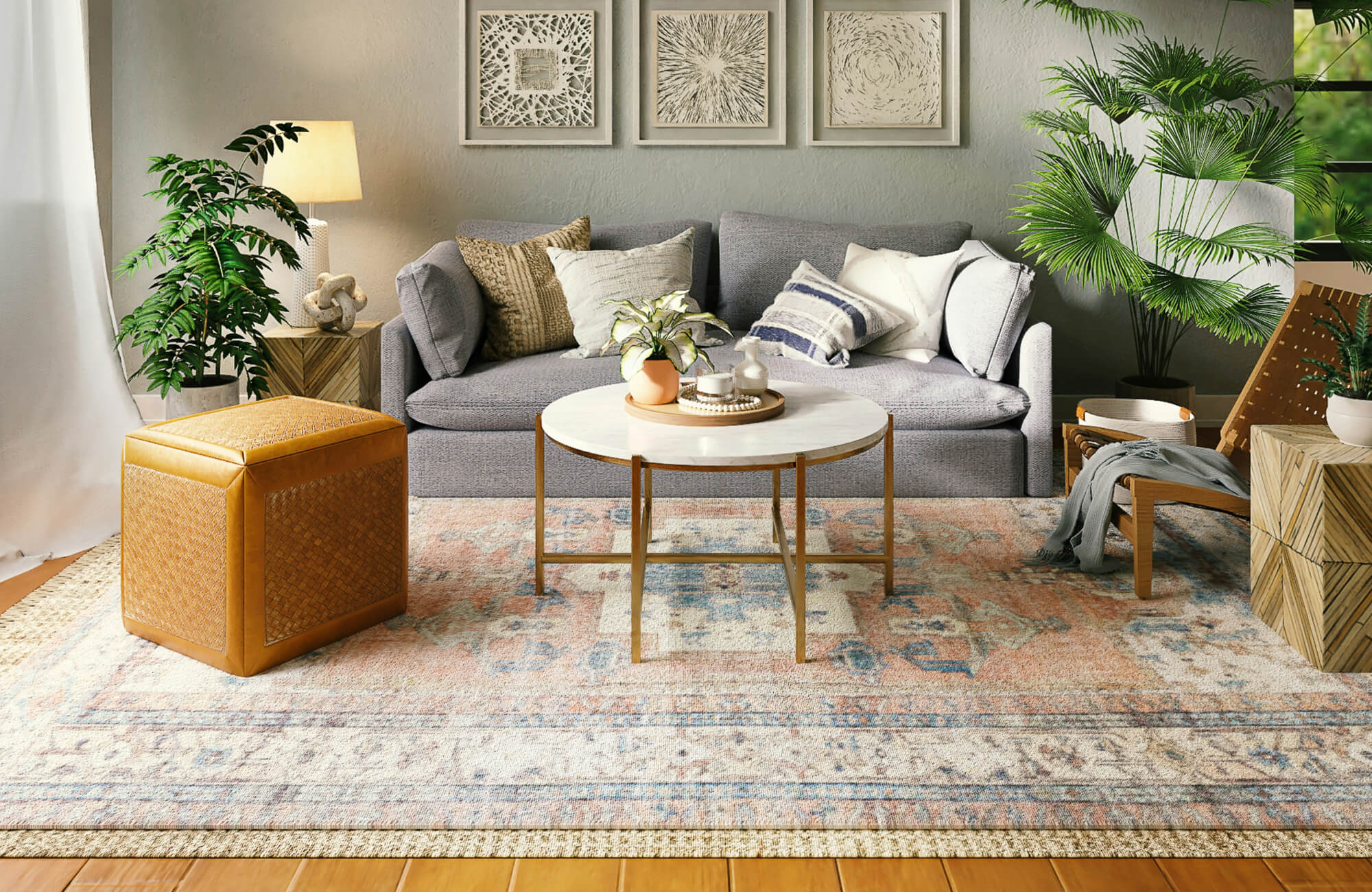 Cozy living room with light wood-look plank flooring, a patterned area rug, gray sofa, layered textiles, and lush greenery.