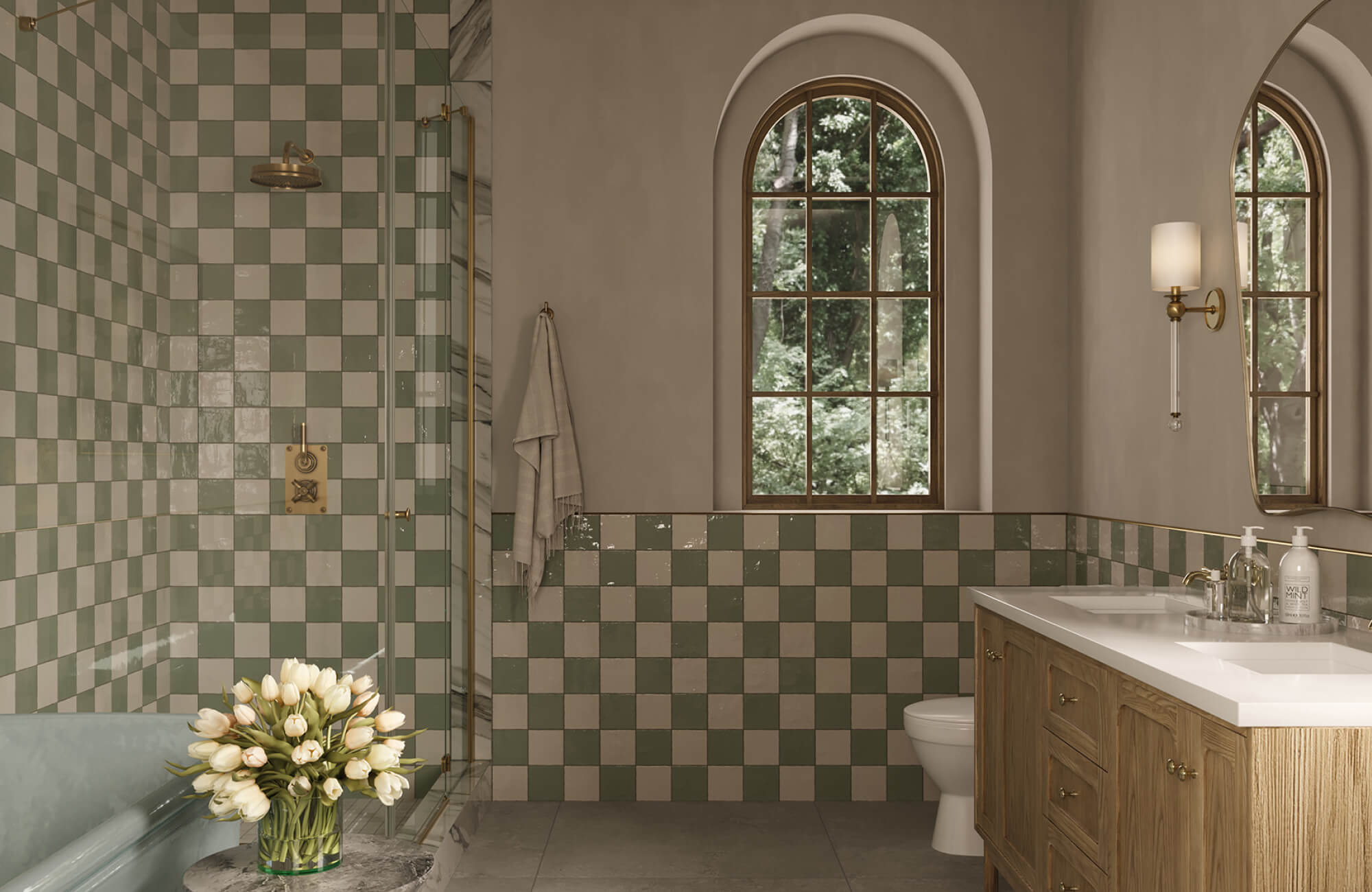 Green checkerboard bathroom wall tile wrapping a shower and tub area, showing glossy surfaces suited for moisture exposure.