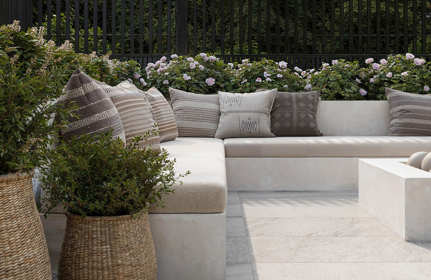 Outdoor sectional seating styled with a mix of decorative pillows, highlighting how standard 18 x 18 sizes blend easily with larger cushions for a balanced arrangement