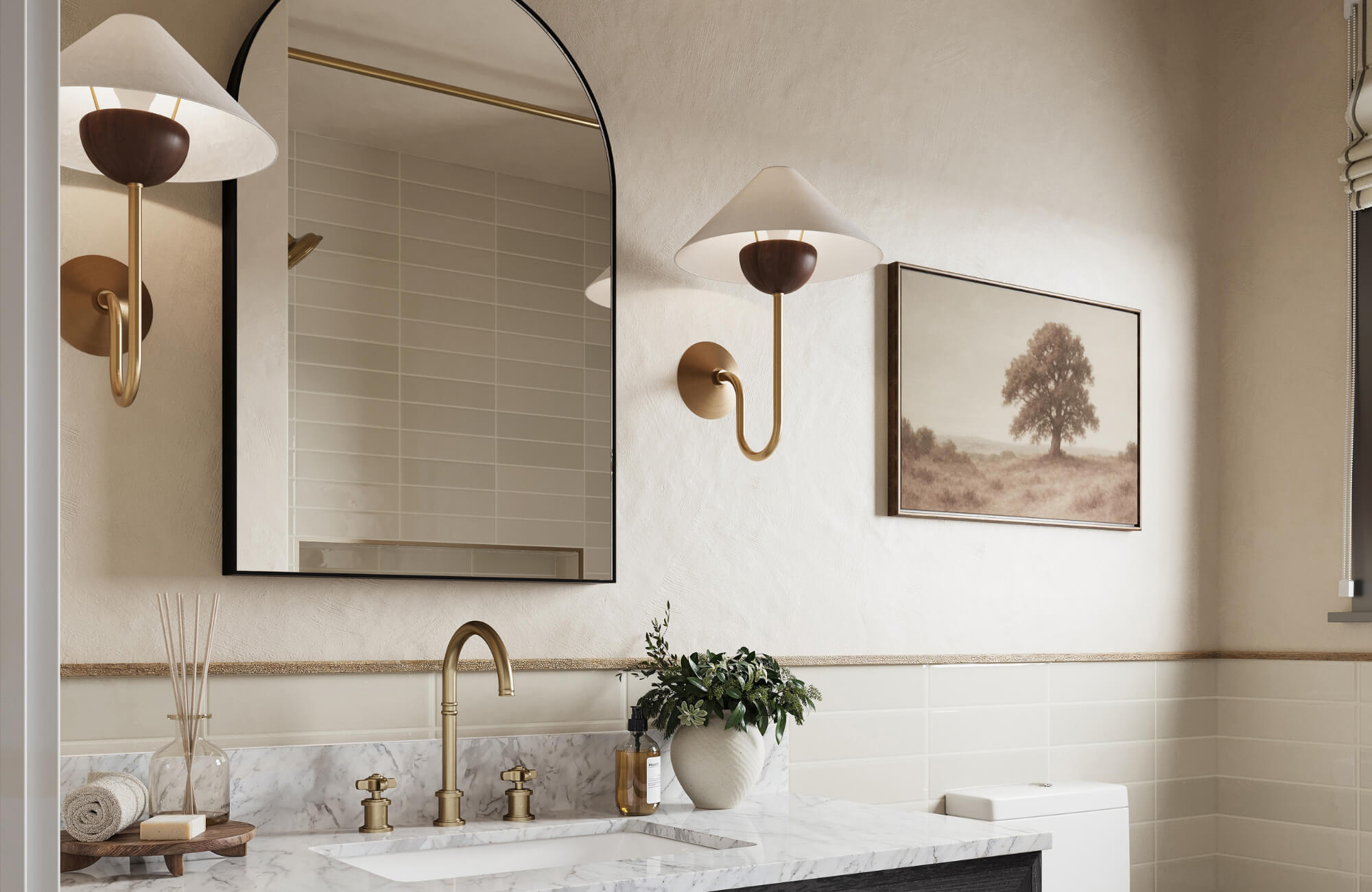 Elegant bathroom with marble countertop, gold fixtures, wall sconces, arched mirror, and neutral-toned decor for a warm, refined look.