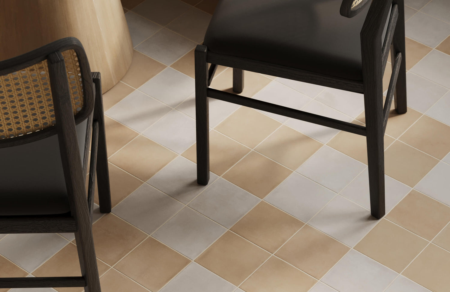 A mix of beige and light gray checkerboard tiles sits under black chairs, bringing a cozy and balanced look to the dining area.