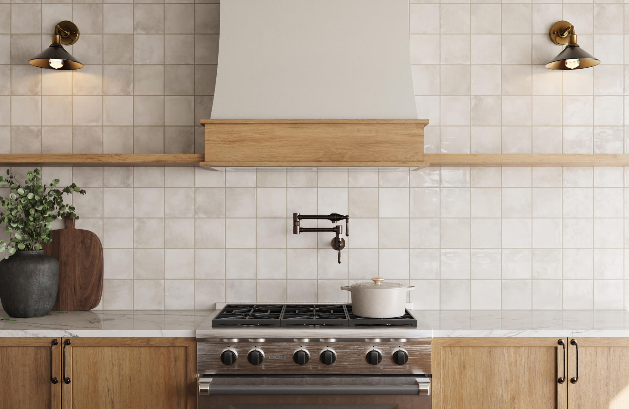Kitchen with artisan ivory zellige backsplash tiles, light oak cabinets, and vintage bronze accents for a rustic handcrafted feel