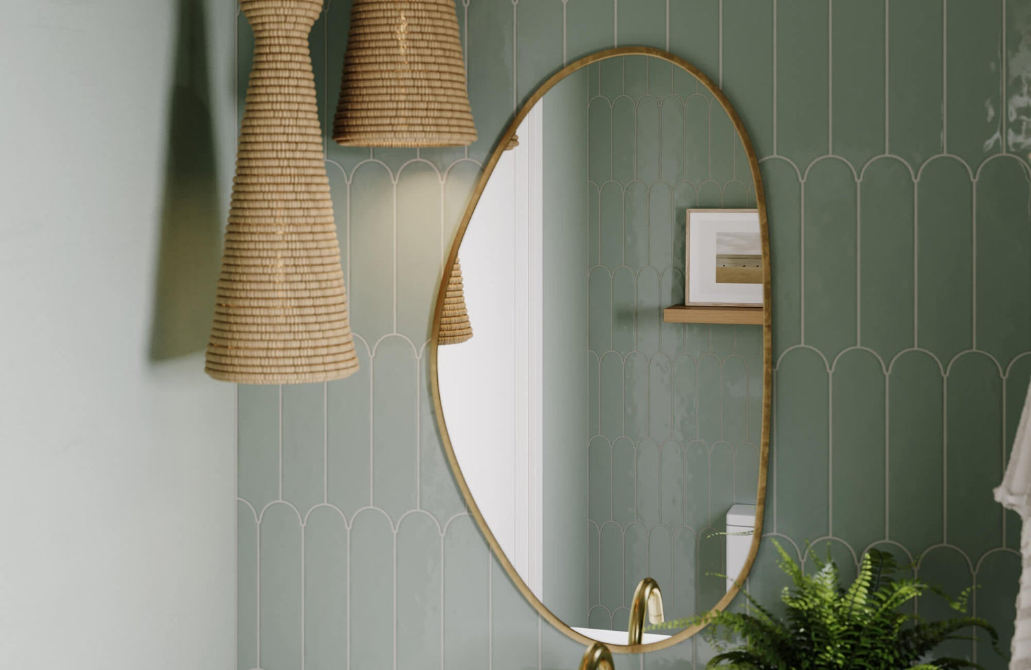 Bathroom featuring a tall oval mirror, green decorative tile walls, and woven pendant lighting for a relaxed boho look.