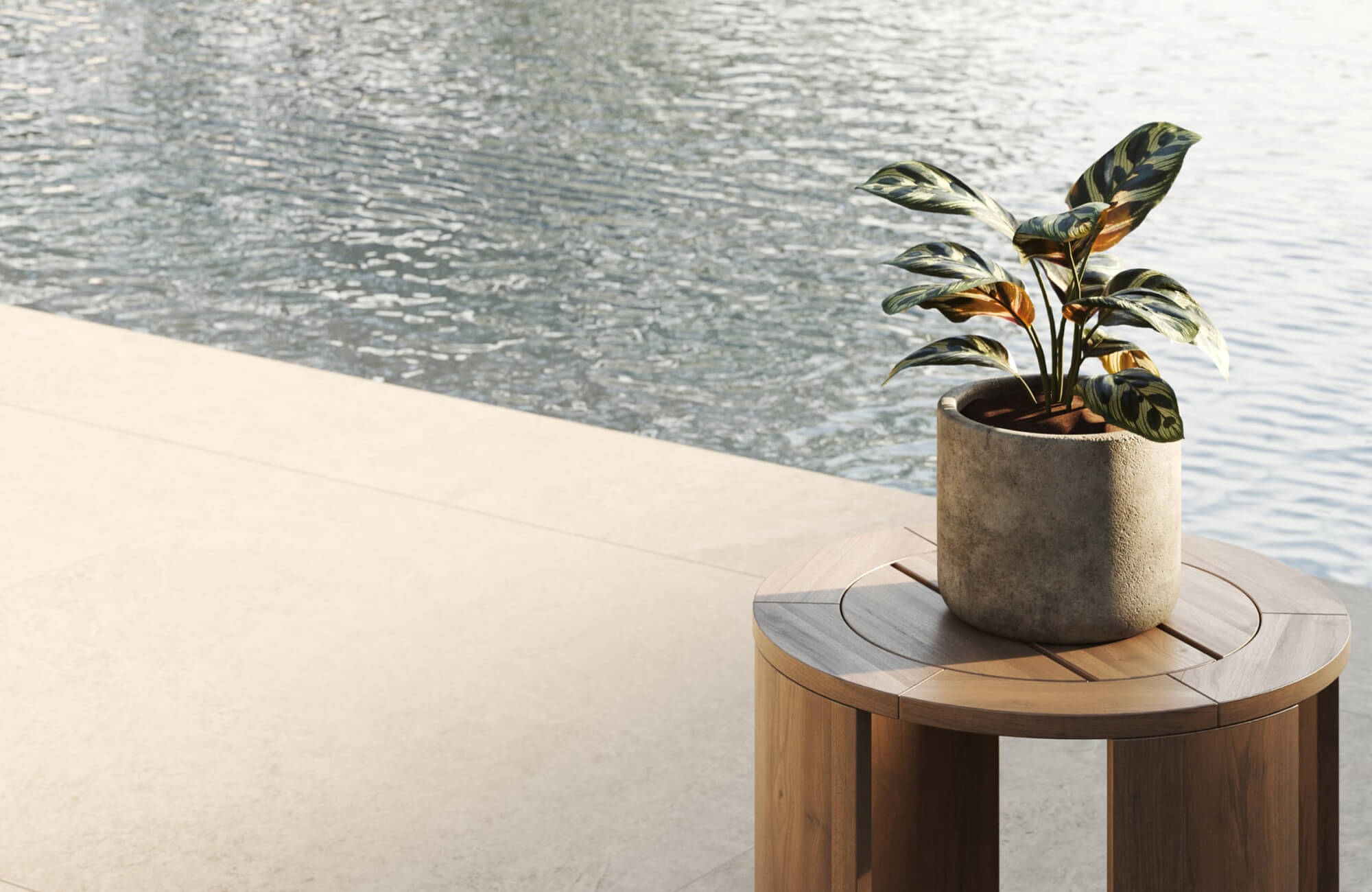 Light-toned outdoor tile bordering a pool, showing a smooth yet matte surface designed to stay stable near water.