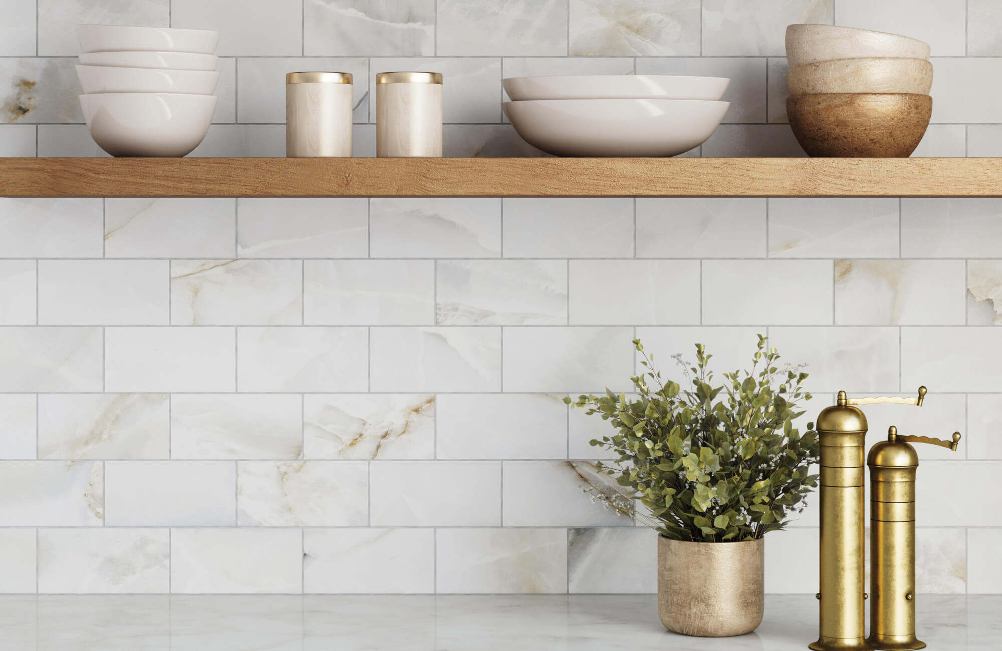 Polished marble look subway tiles with golden veining complement rustic wood shelving and brass kitchen accents.