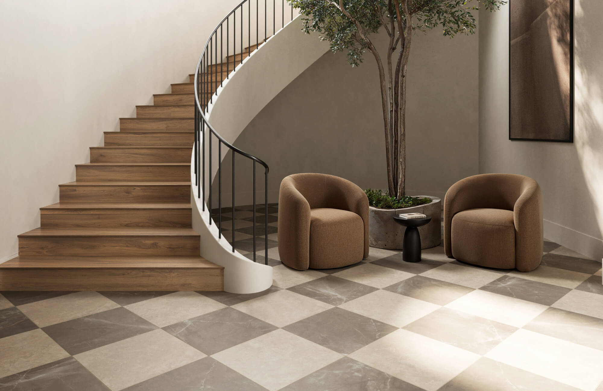 Modern minimalist entryway with warm neutrals featuring a beige and brown checkerboard floor, curved staircase, and cozy seating.