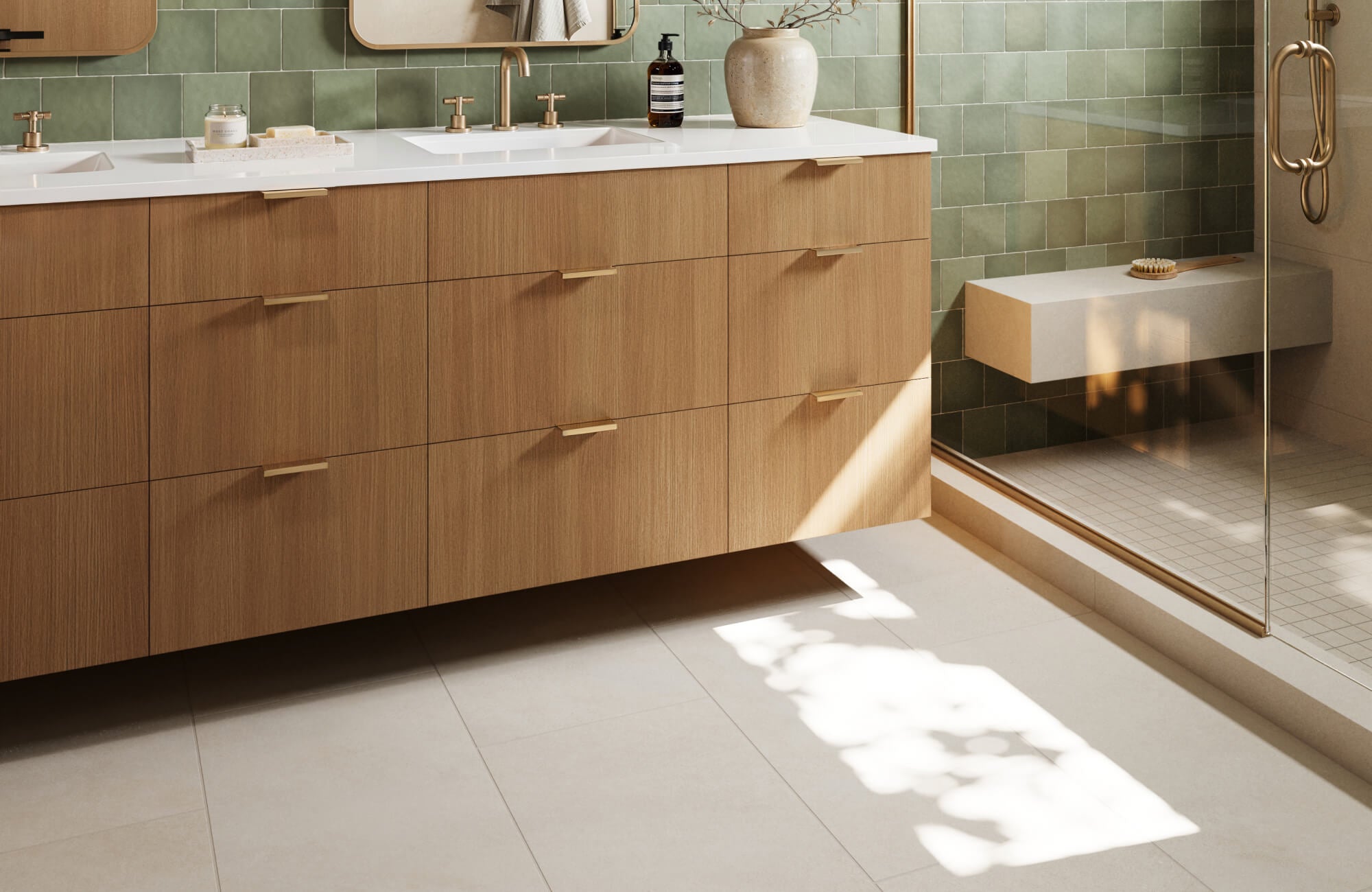 Warm-toned wood vanity with brass accents pairs beautifully with sage green wall and beige floor tiles, adding a touch of organic elegance to the bathroom.