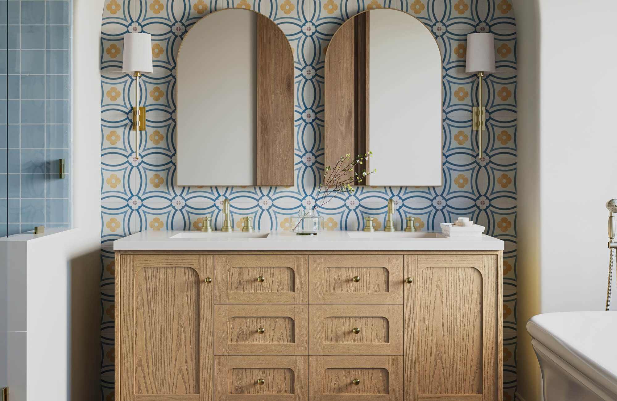 Charming bathroom with blue and gold floral patterned tile backsplash, arched mirrors, and a natural wood double vanity
