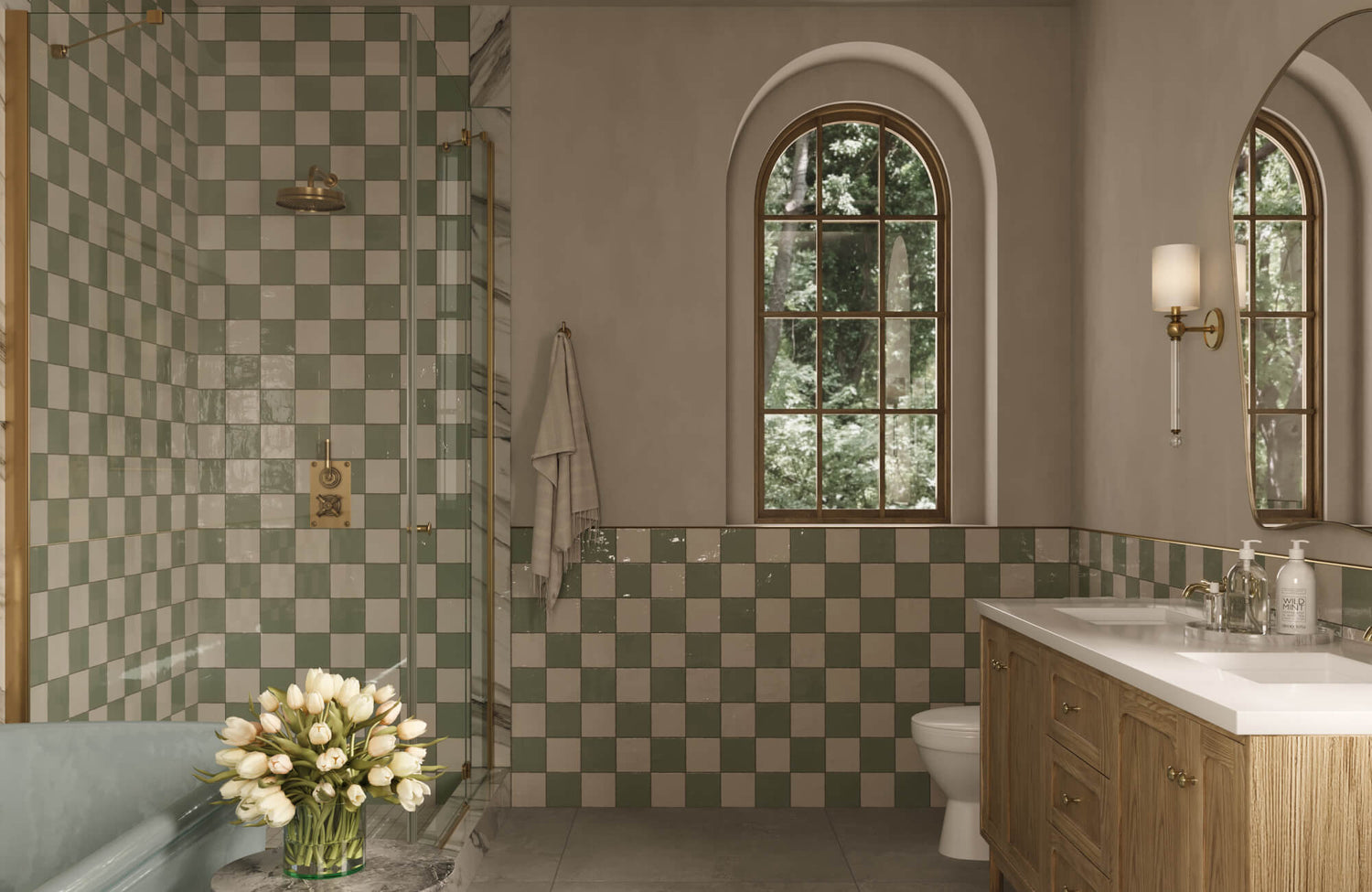 Sage and cream checkerboard wall tiles add vintage elegance to this bathroom with arched windows and brass accents.