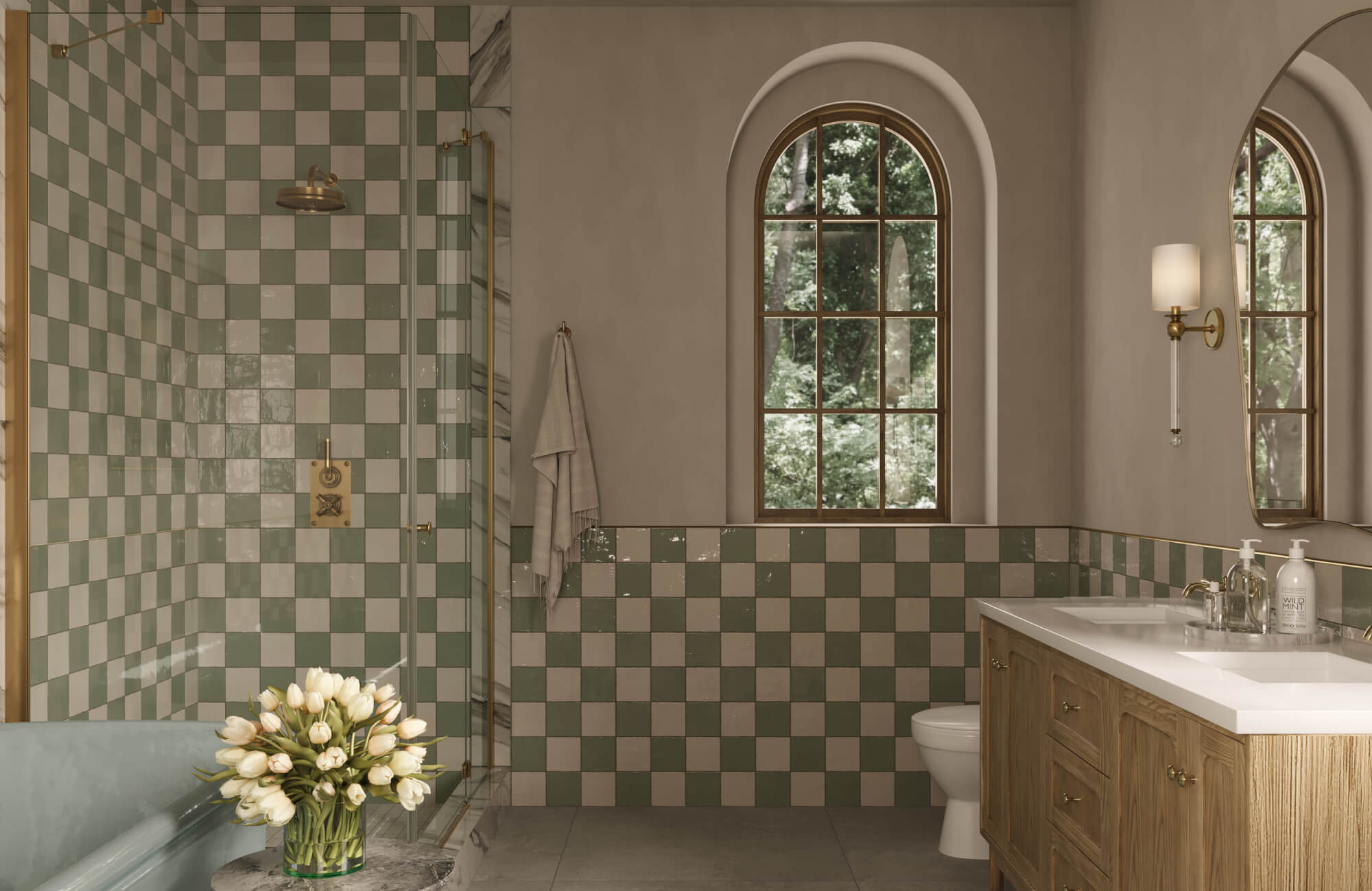 Sage and cream checkerboard wall tiles add vintage elegance to this bathroom with arched windows and brass accents.