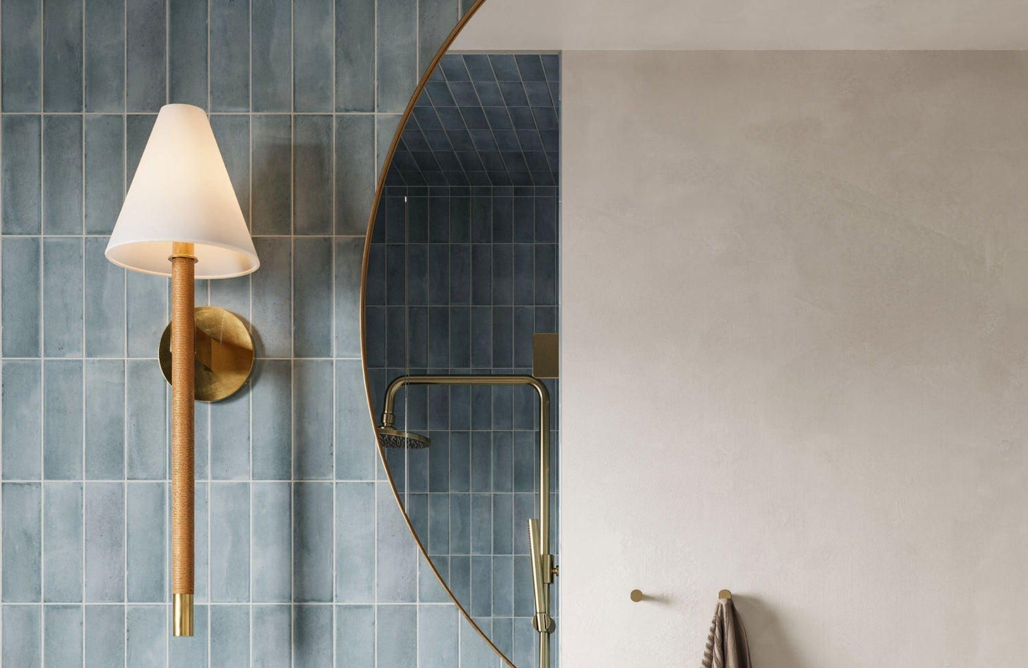 Large round mirror above bathroom vanity reflecting tile and shower for a balanced, functional focal point.