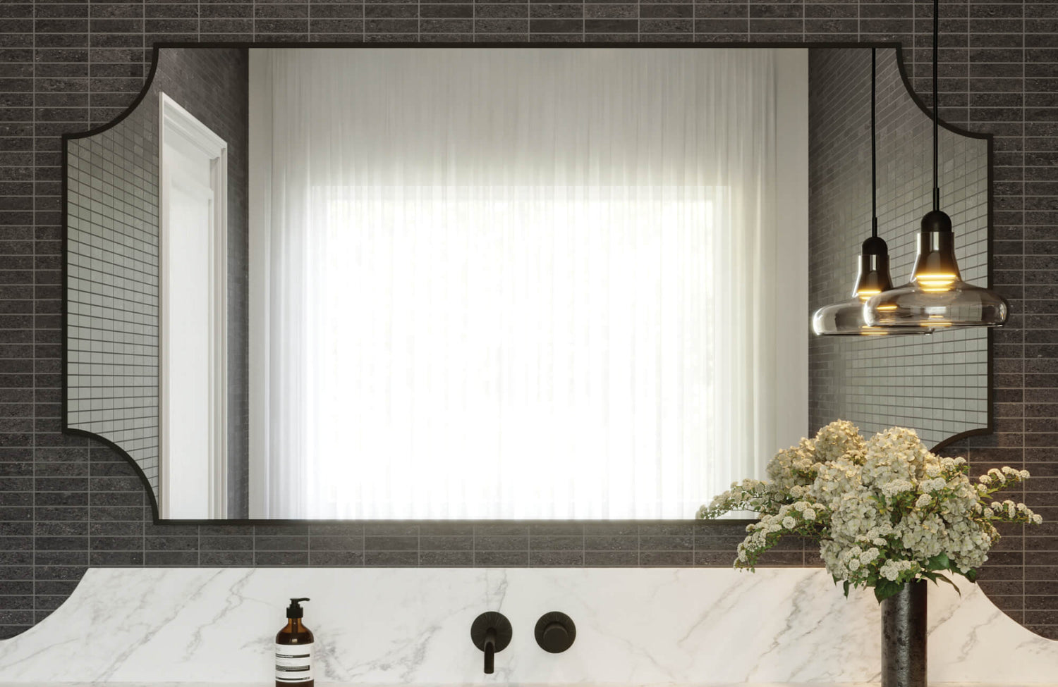 Sleek bathroom with a sculpted-edge rectangular mirror, white marble vanity, dark linear tiles, and black matte fixtures.