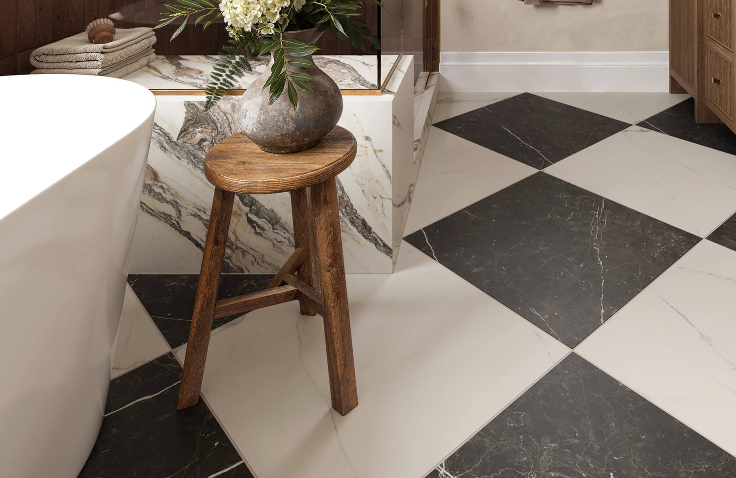 Elegant bathroom showcasing large black and white marble tiles arranged in a bold checkerboard pattern, complemented by natural wood cabinetry and a rustic stool that add warmth to the sophisticated space.