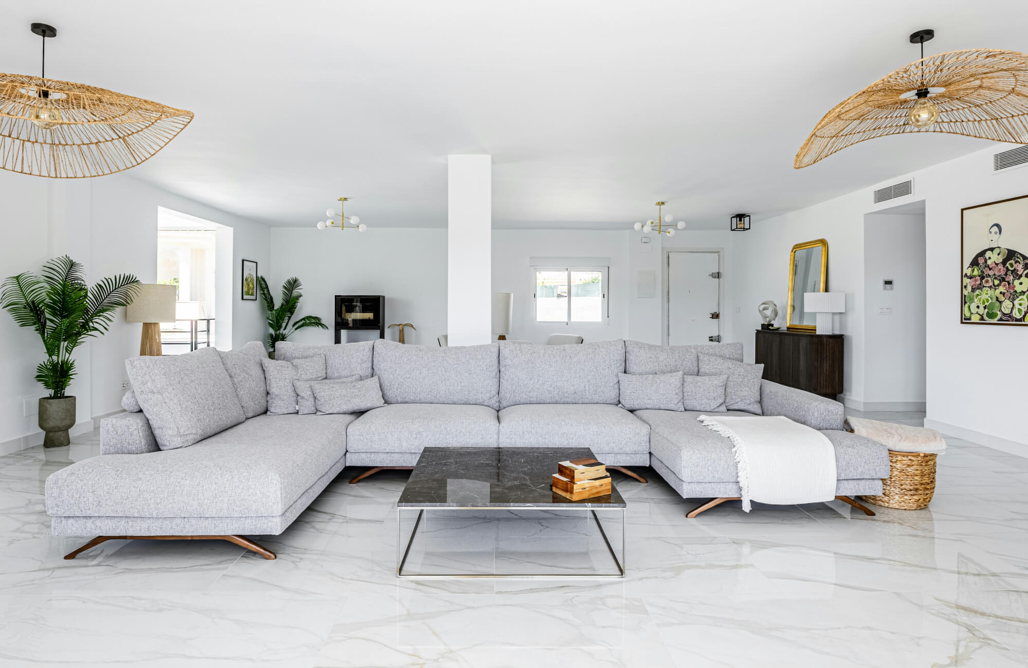 Modern living room with glossy white marble-look tile flooring, enhancing the bright open space with elegance and sophistication.